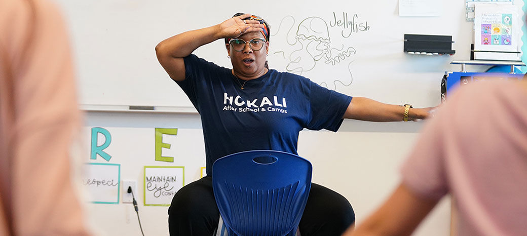 Dance instructor teaching foundational hip hop techniques to students