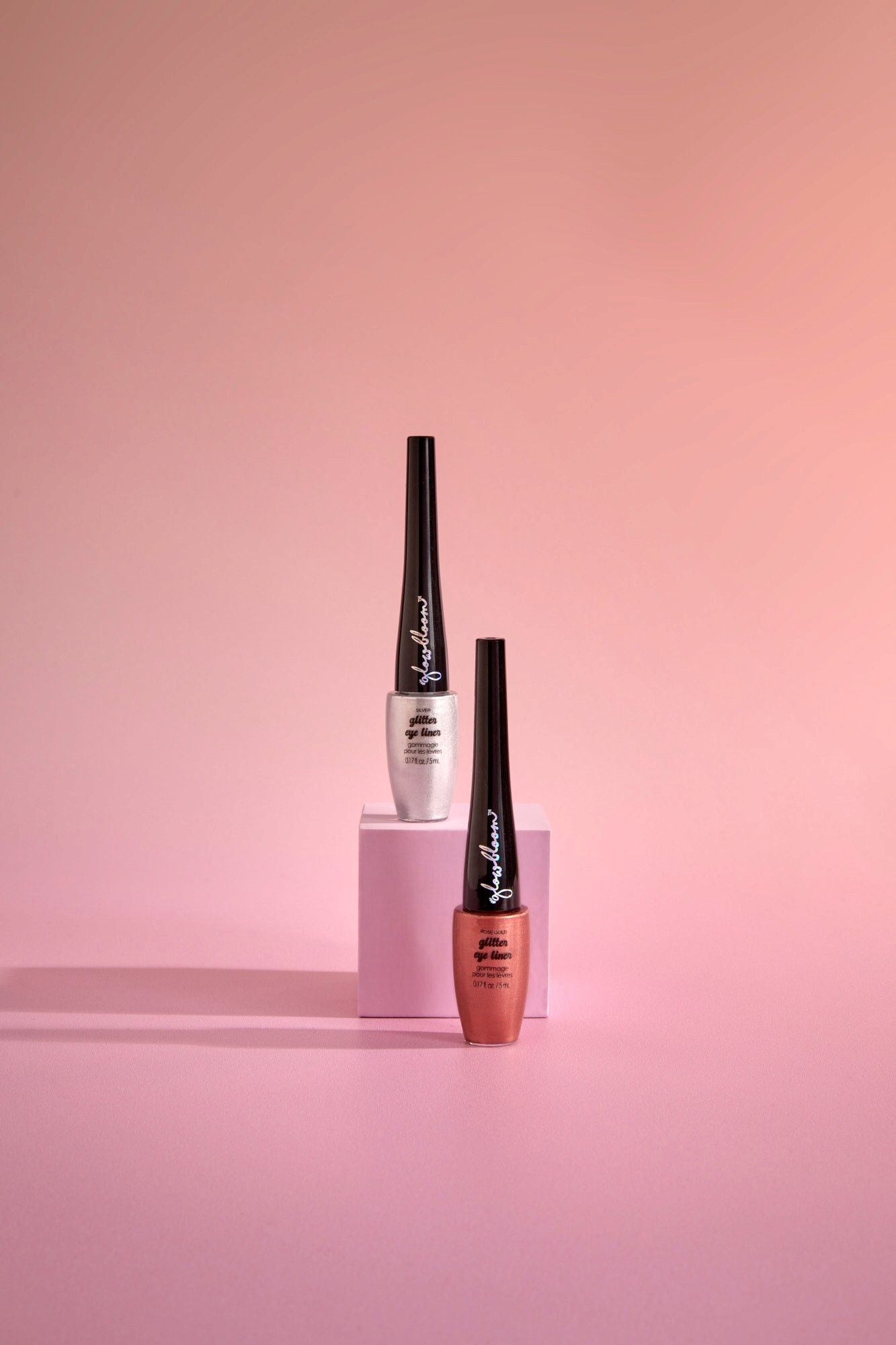 Minimalist design of two stacked boxes, one in sleek gray and the other in vibrant yellow, with branding initials 'SP,' illuminated by soft natural light.