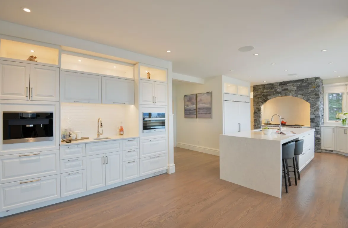Image of Modern kitchen design with white cabinetry, island seating, and layout design by KHD Homes builder.
