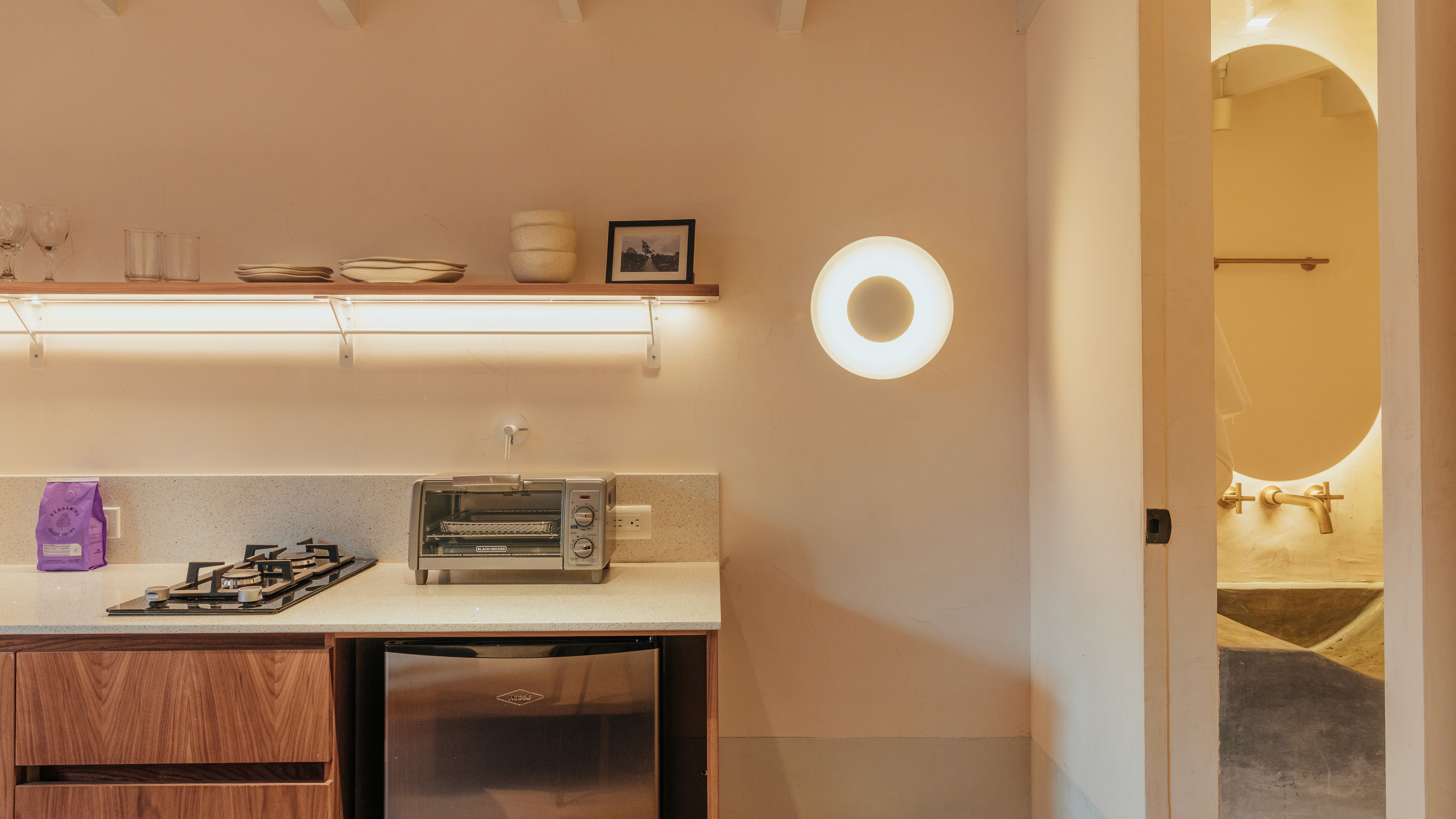Double-height interior with flowing sculptural forms and warm raking light