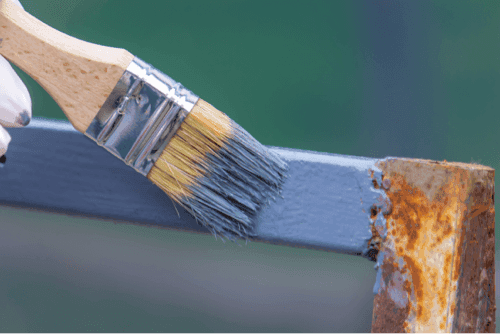 A brush applying paint