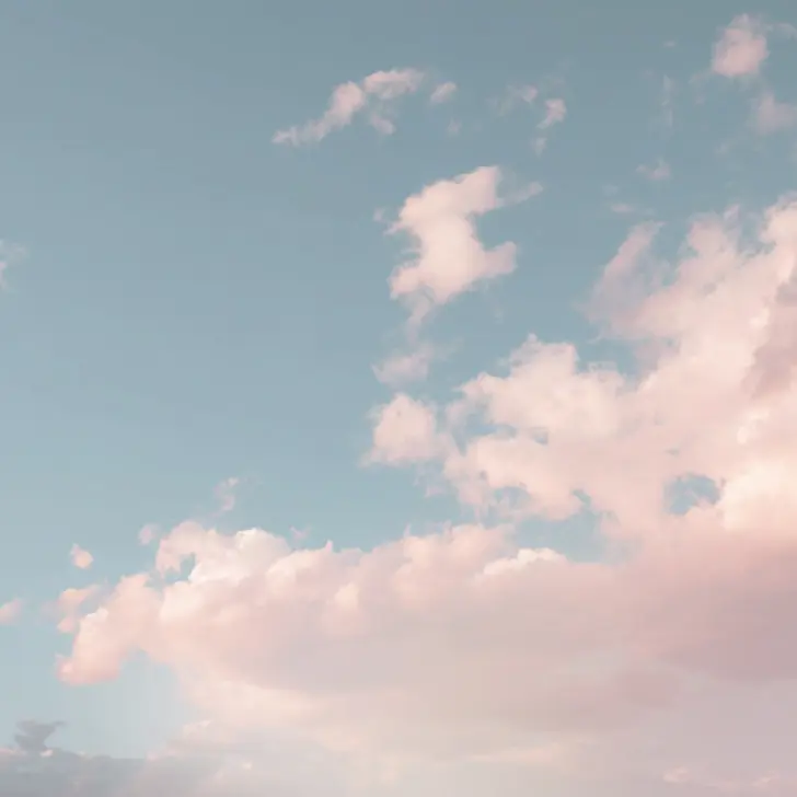 Pink clouds against a blue sky