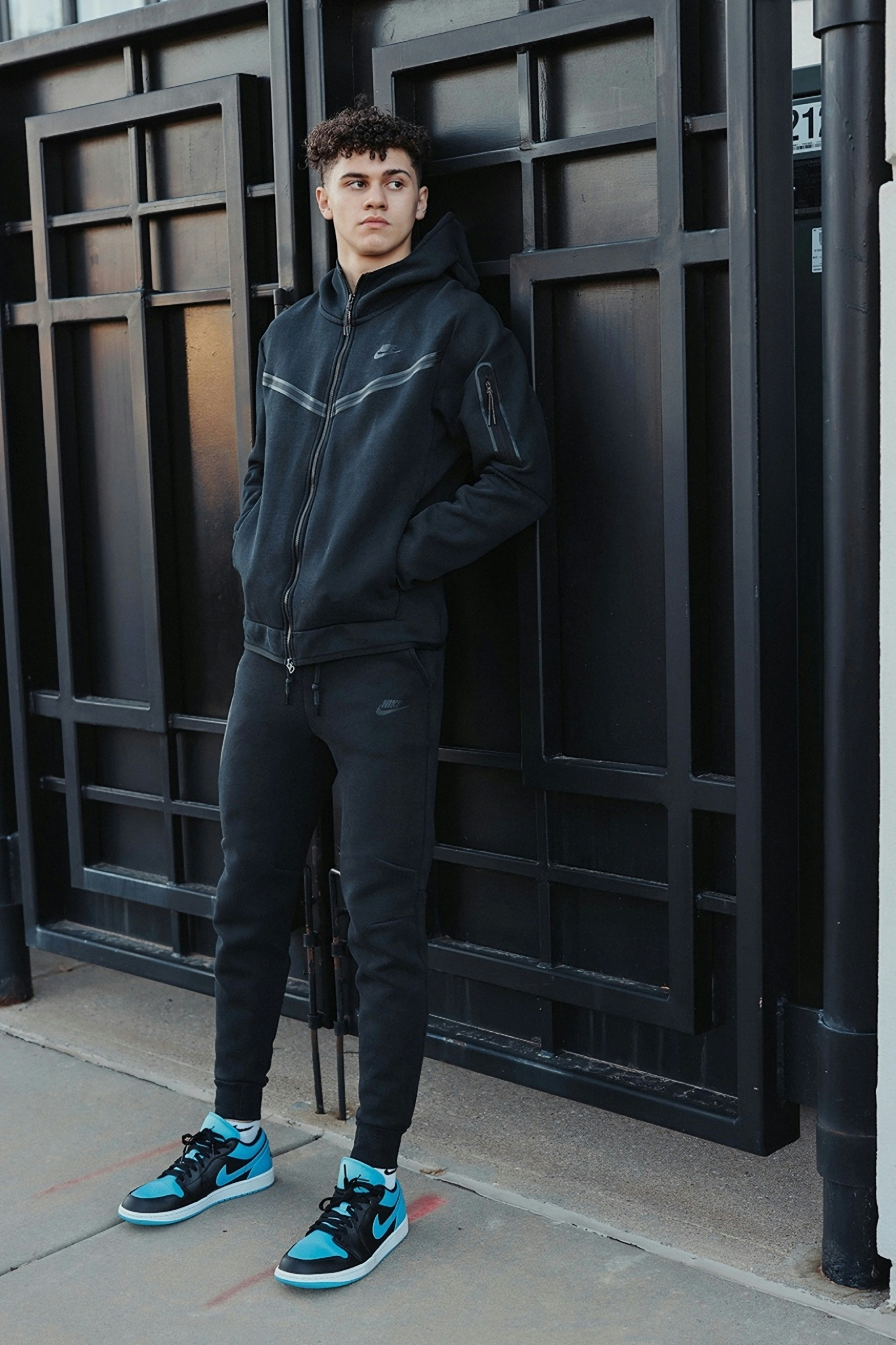 Young man in black tracksuit and sneakers