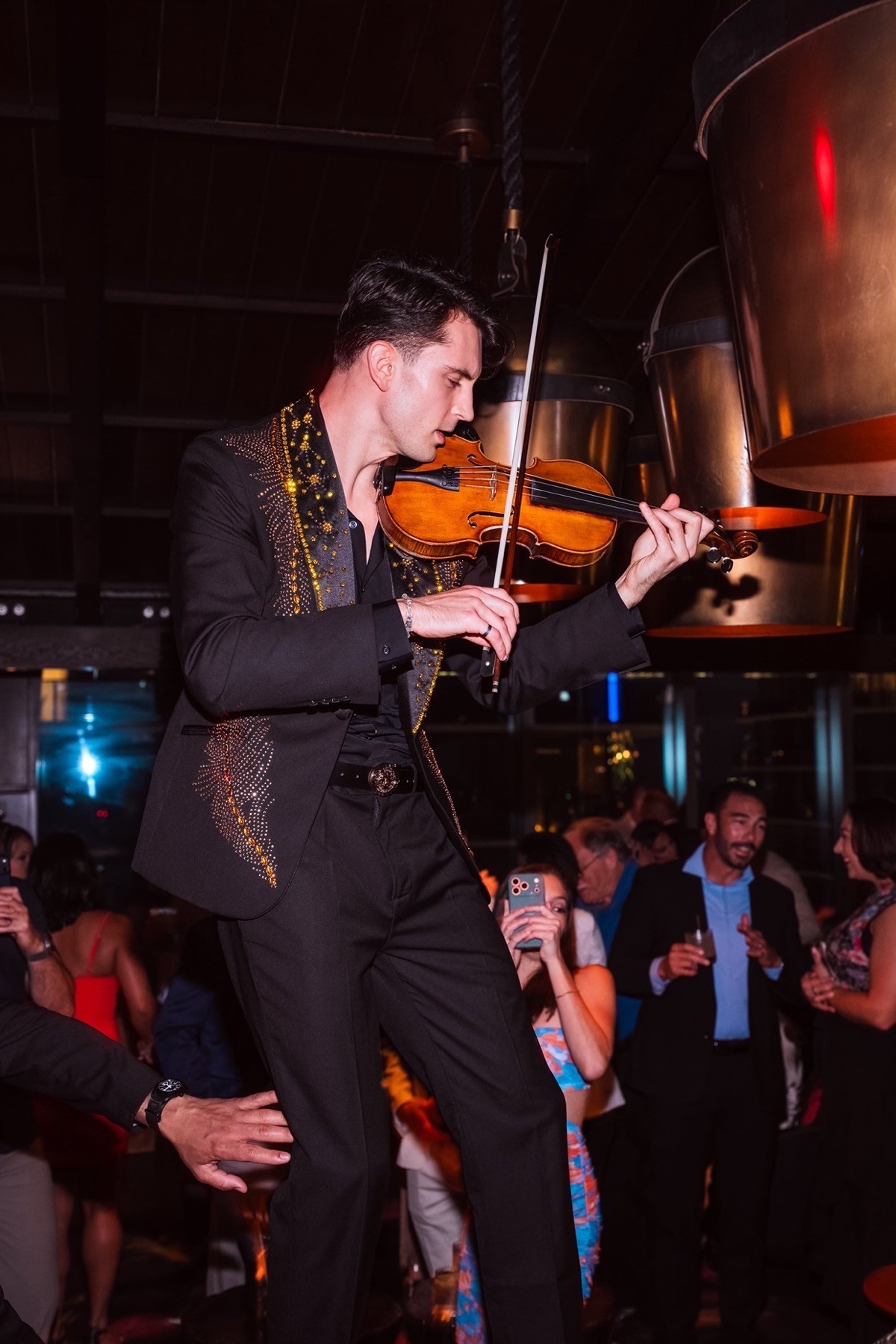 Marki Lucky performing violin at a gala