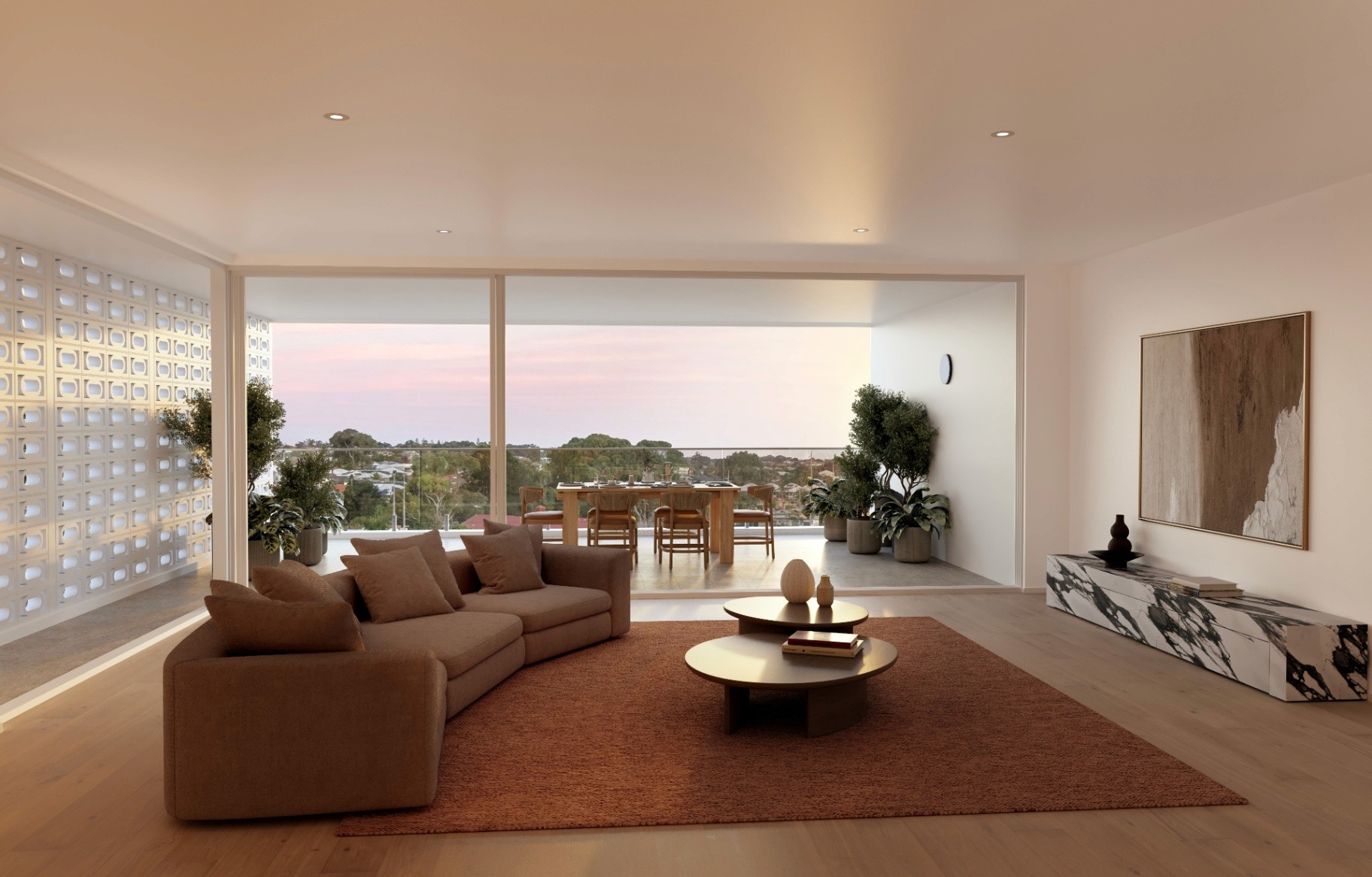Open-plan living area flowing to a large balcony with outdoor dining and coastal views in a luxury Scarborough townhouse