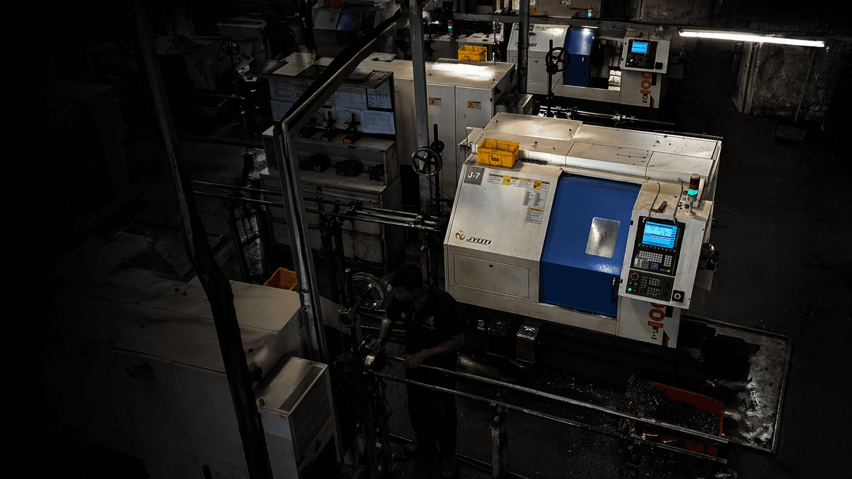 gray vehicle being fixed inside factory using robot machines