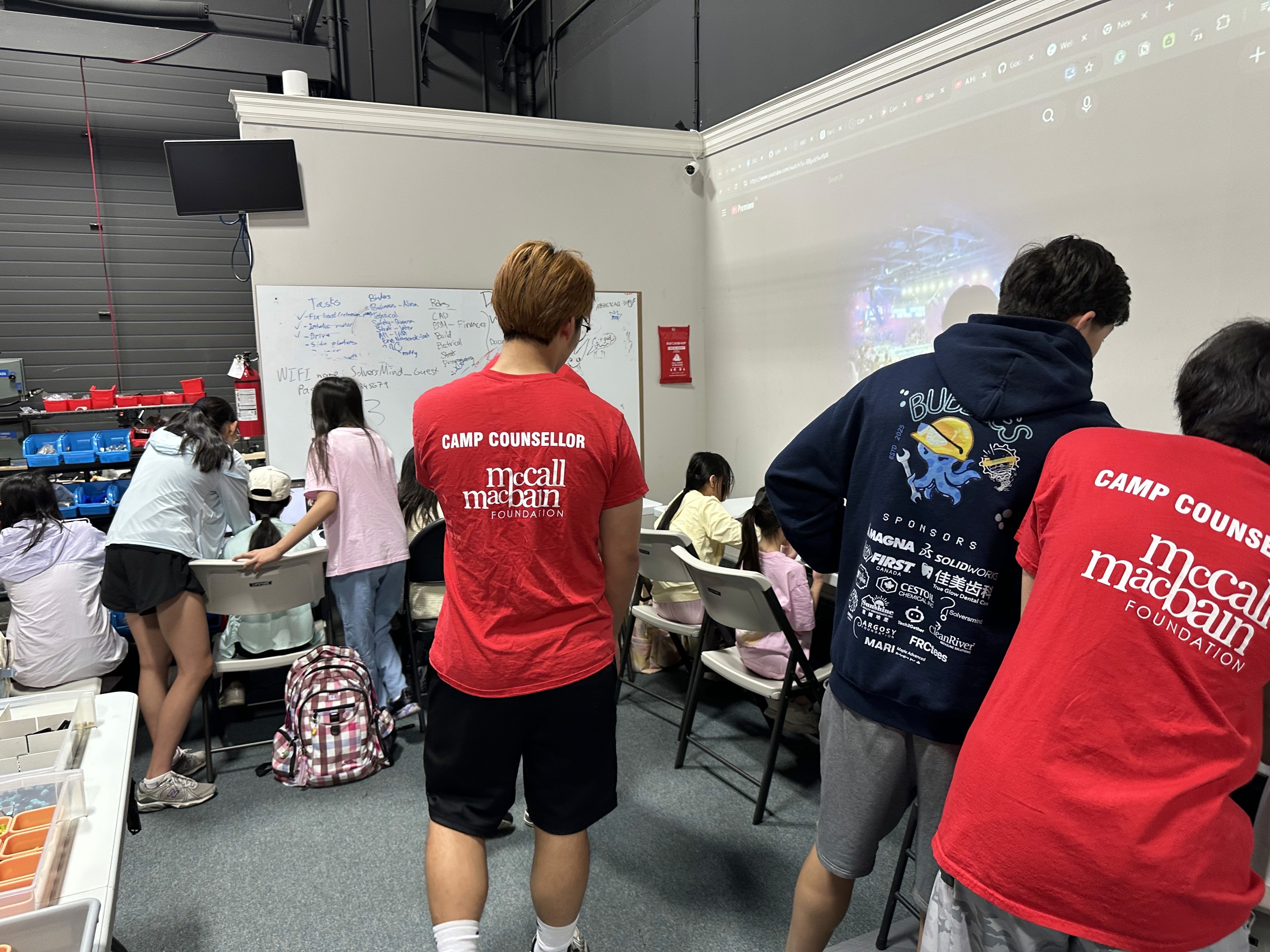 FRC 10015 Bubbles student volunteers serve as camp counsellors to mentor campers at the Solversmind Robotics studio in Aurora.