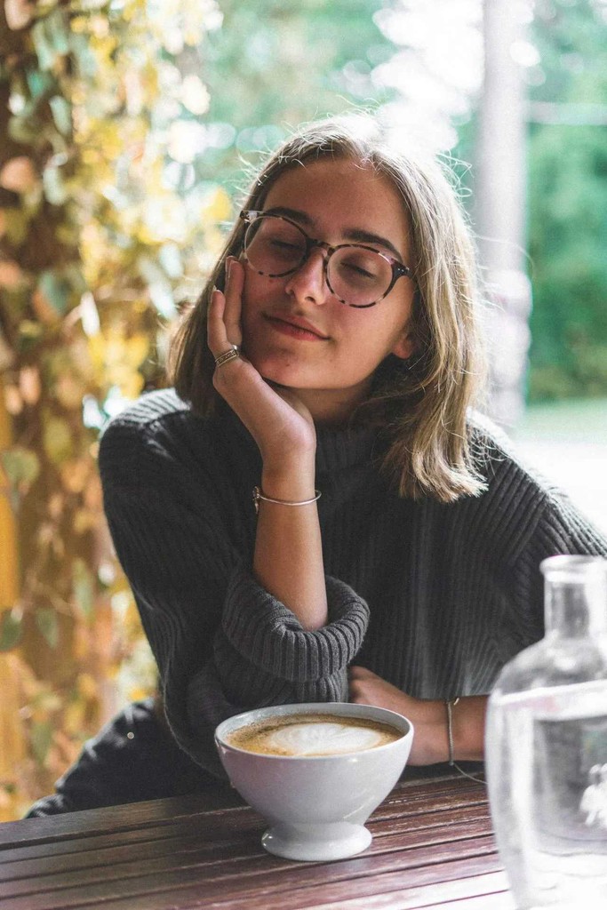 A woman in glasses relaxing peacefully
