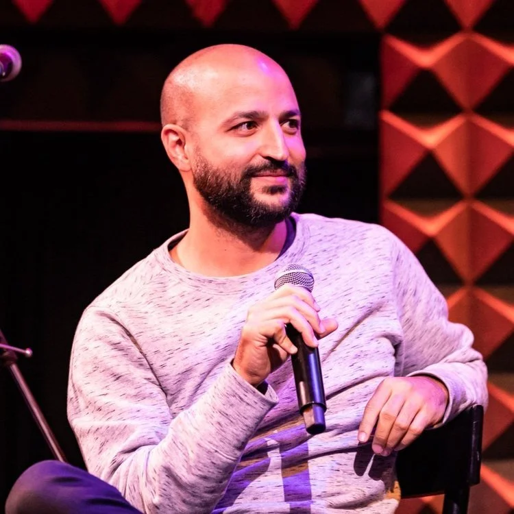 man in green crew neck shirt and black hat