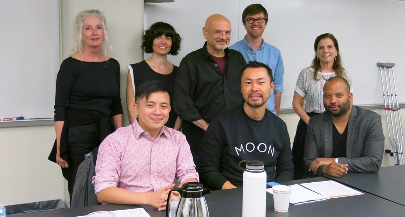 A photo of a group of people sitting in an office.