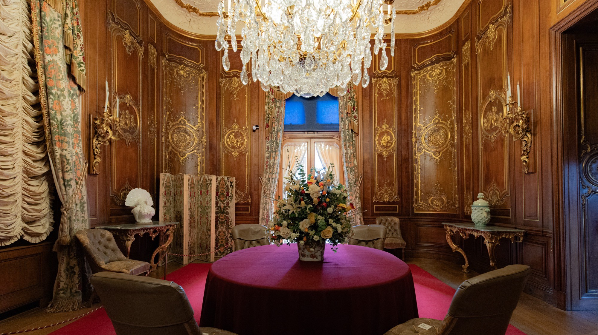 Two classic volkswagen beetles, one green, one cream.