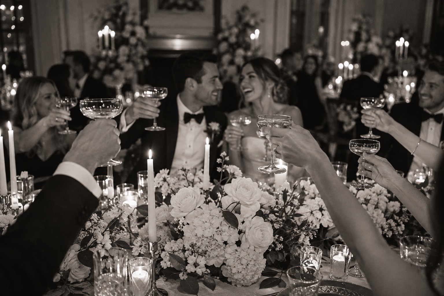 Wedding reception toast with champagne glasses and flowers