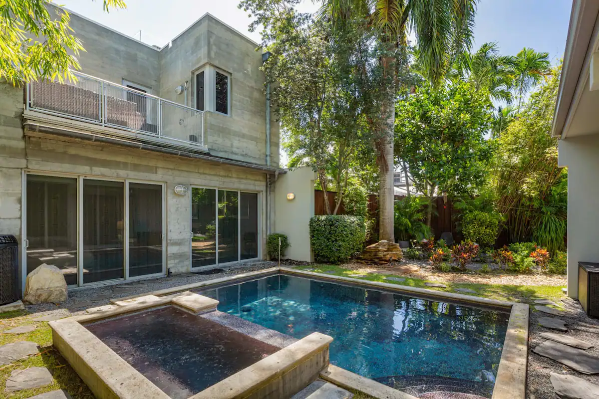 tranquil pool area surrounded by lush greenery—an exclusive Key West sanctuary for relaxation