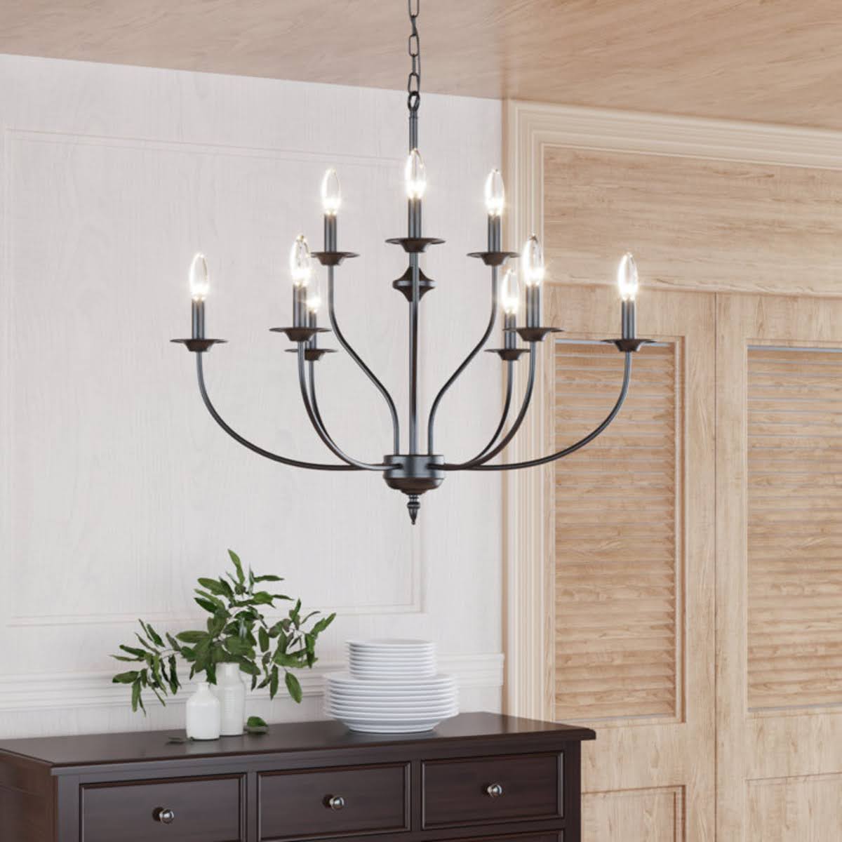 Traditional chandelier with black arms and lightbulbs that look like candles.