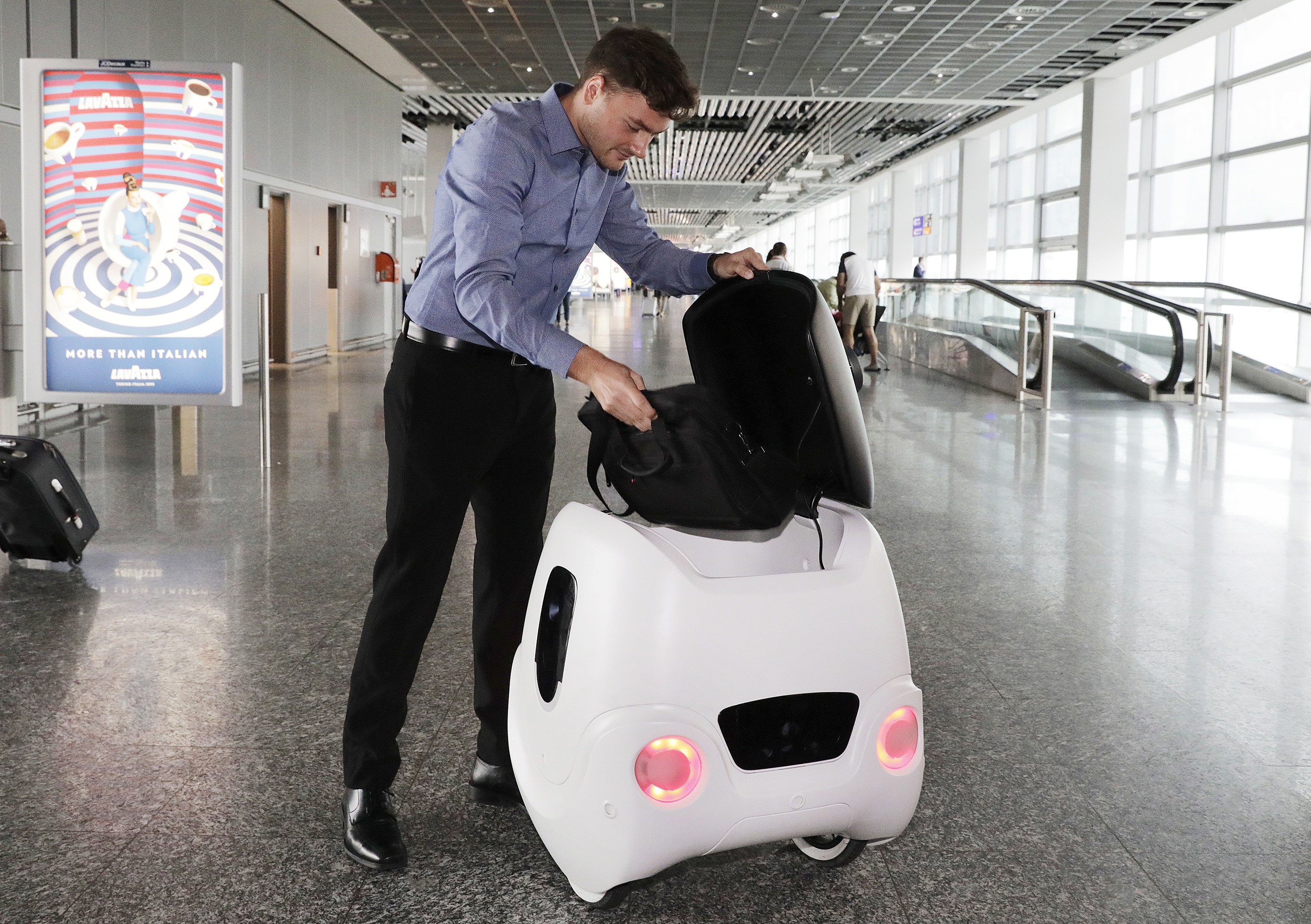 Self-driving transport robot helps passengers carry small luggage and navigate through the terminals