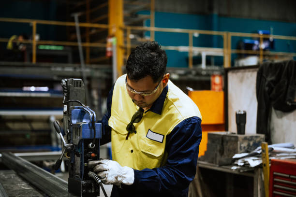 image of a man operating fabrication equiptment wearing protective gear