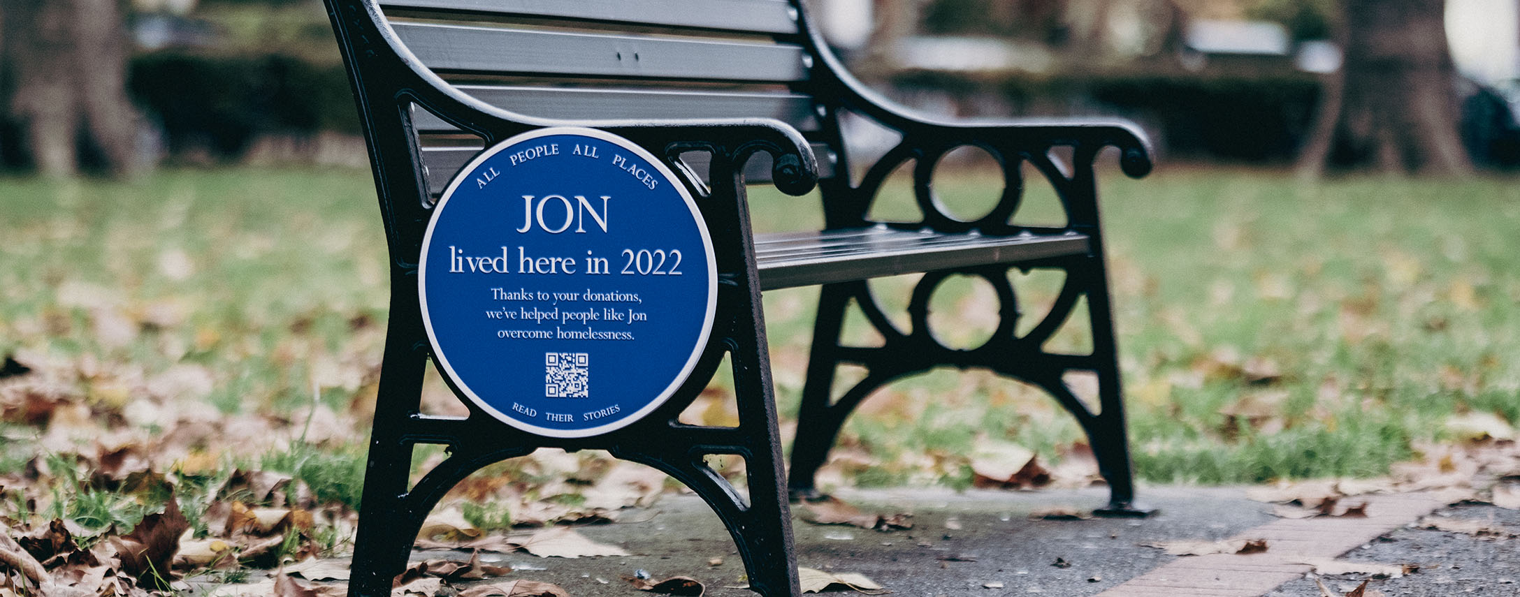 Blue plaque on a park bench
