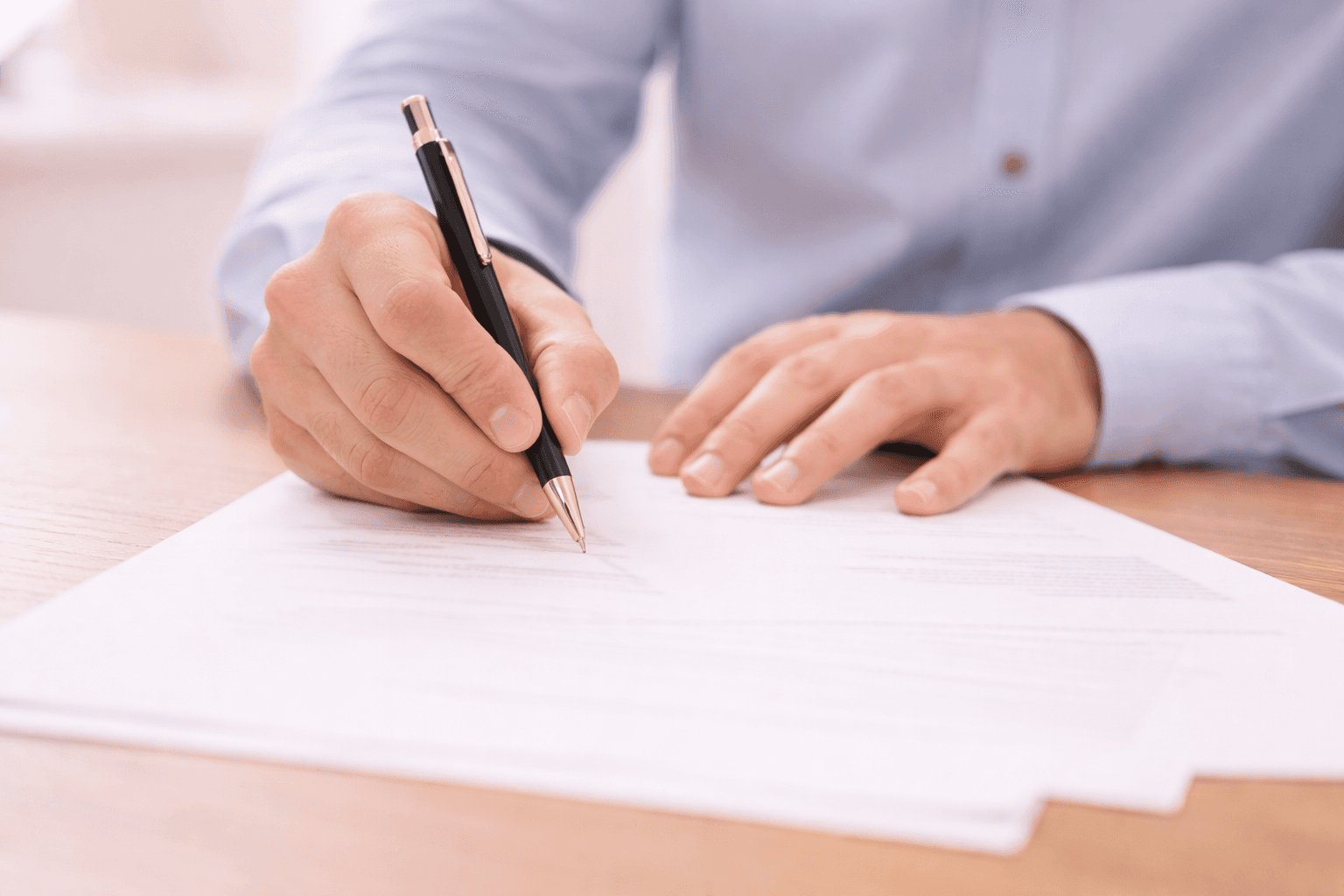man writing on paper