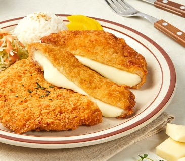 A man stading with Surfboard