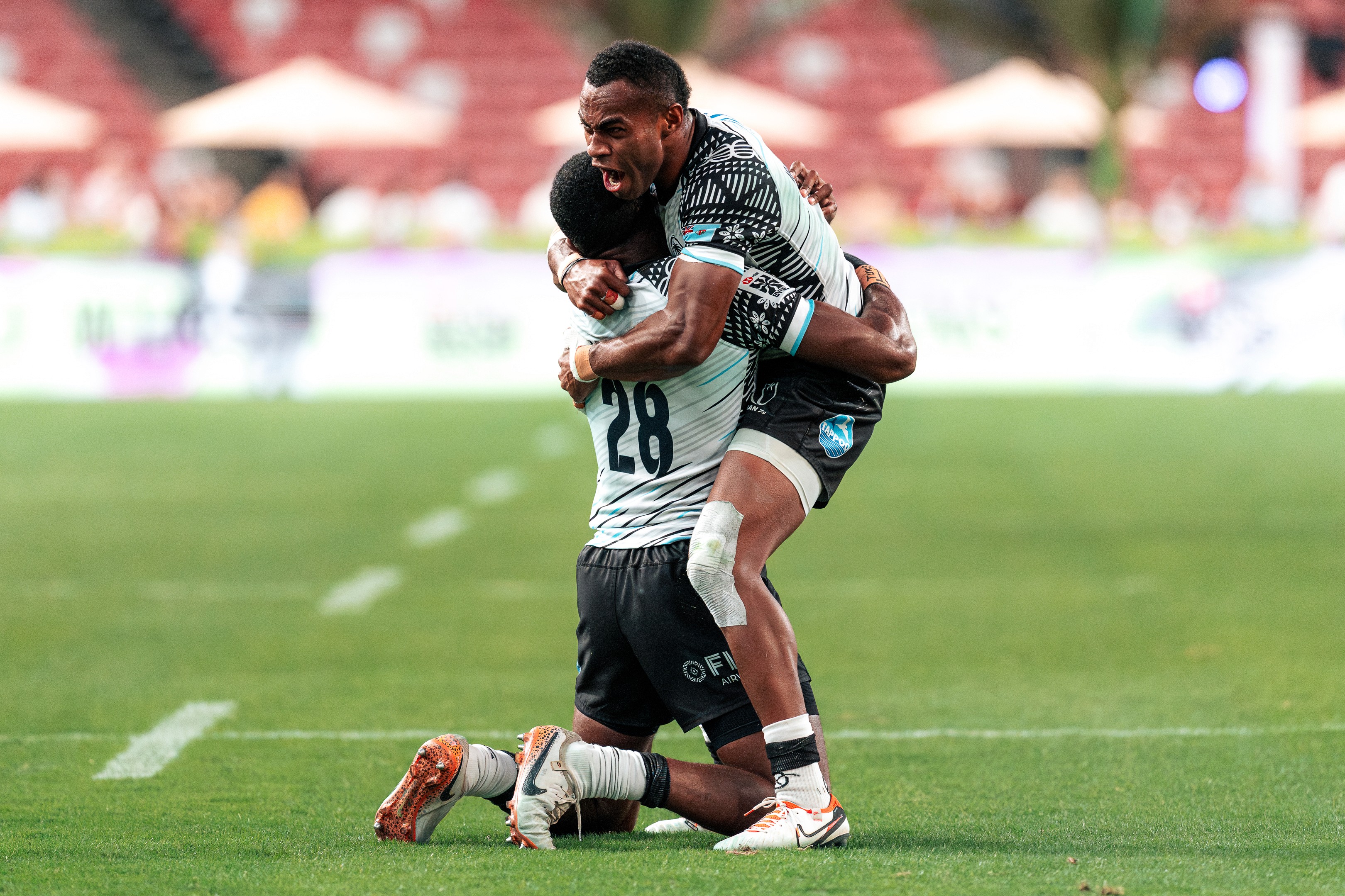 Vuiviwa Naduvalo and Alusio Vakadranu of Fiji celebrate after winning the final of the HSBC SVNS Singapore 2025