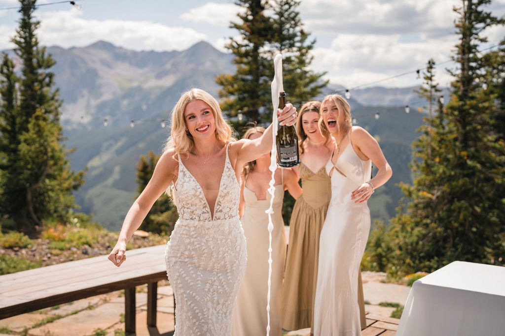 Bride and attendants celebrating beside a mountaintop table