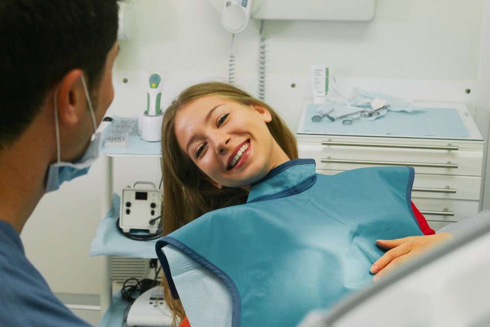 Happy Patient in Dental chair consulting with doctor bird about tooth colored fillings in Boise, Idaho.