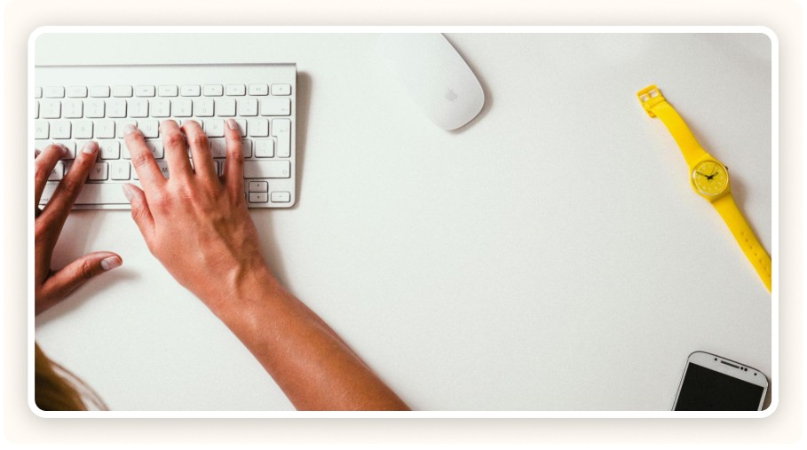 A person typing on a computer keyboard