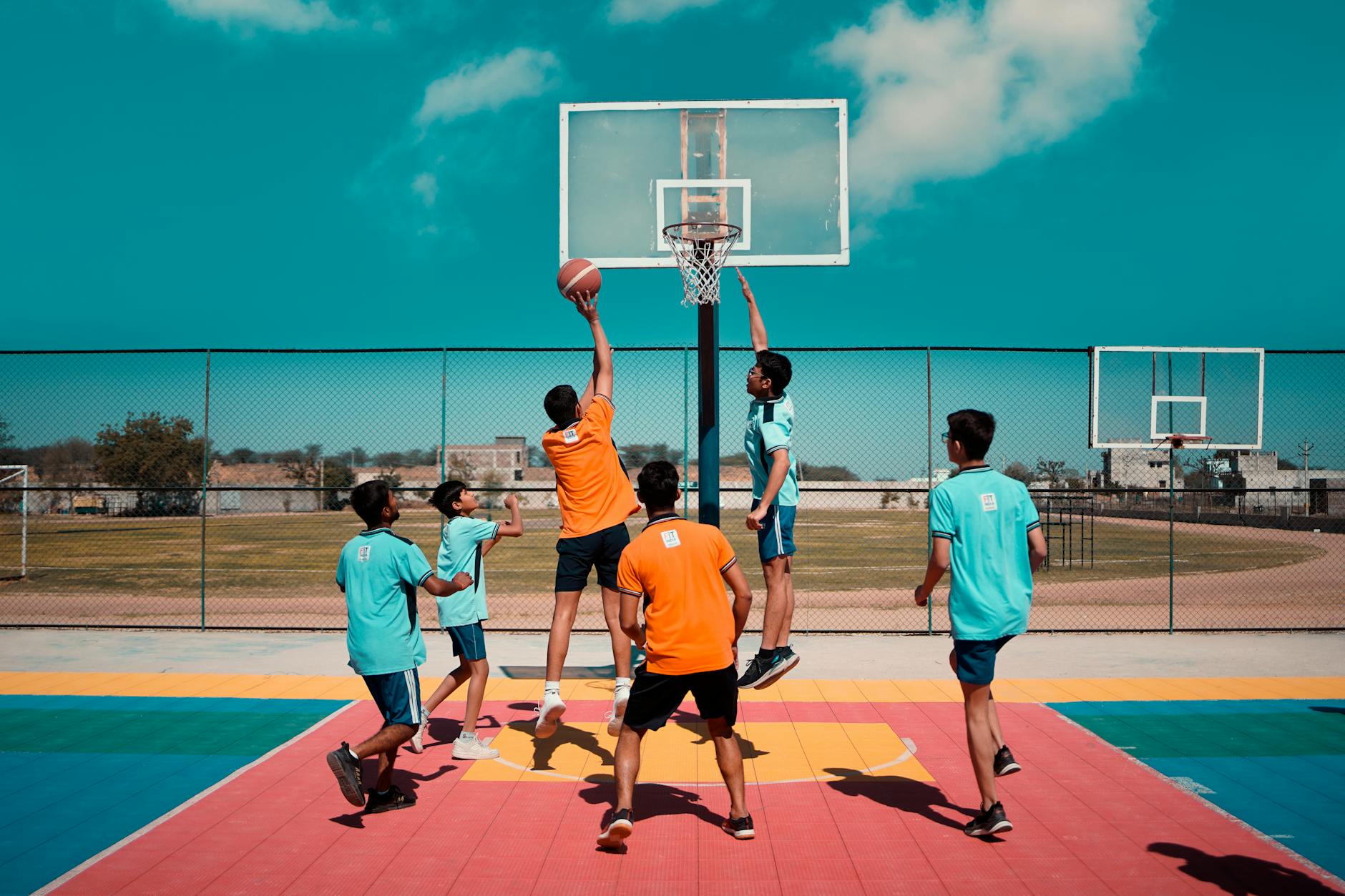 A close-up of a student's hands correctly positioning a basketball for a chest pass during a skills drill.