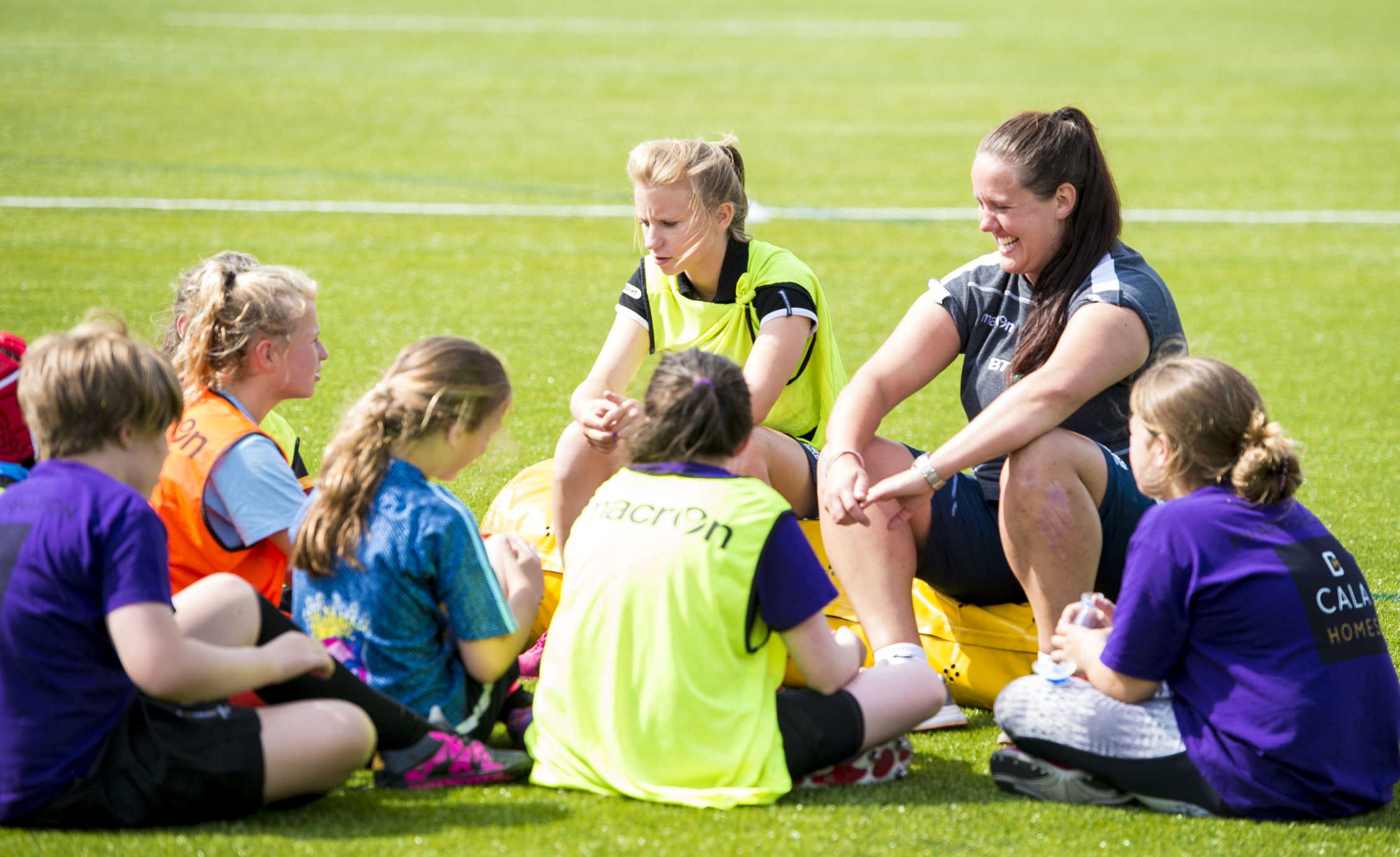 rugby coach with kids smiling