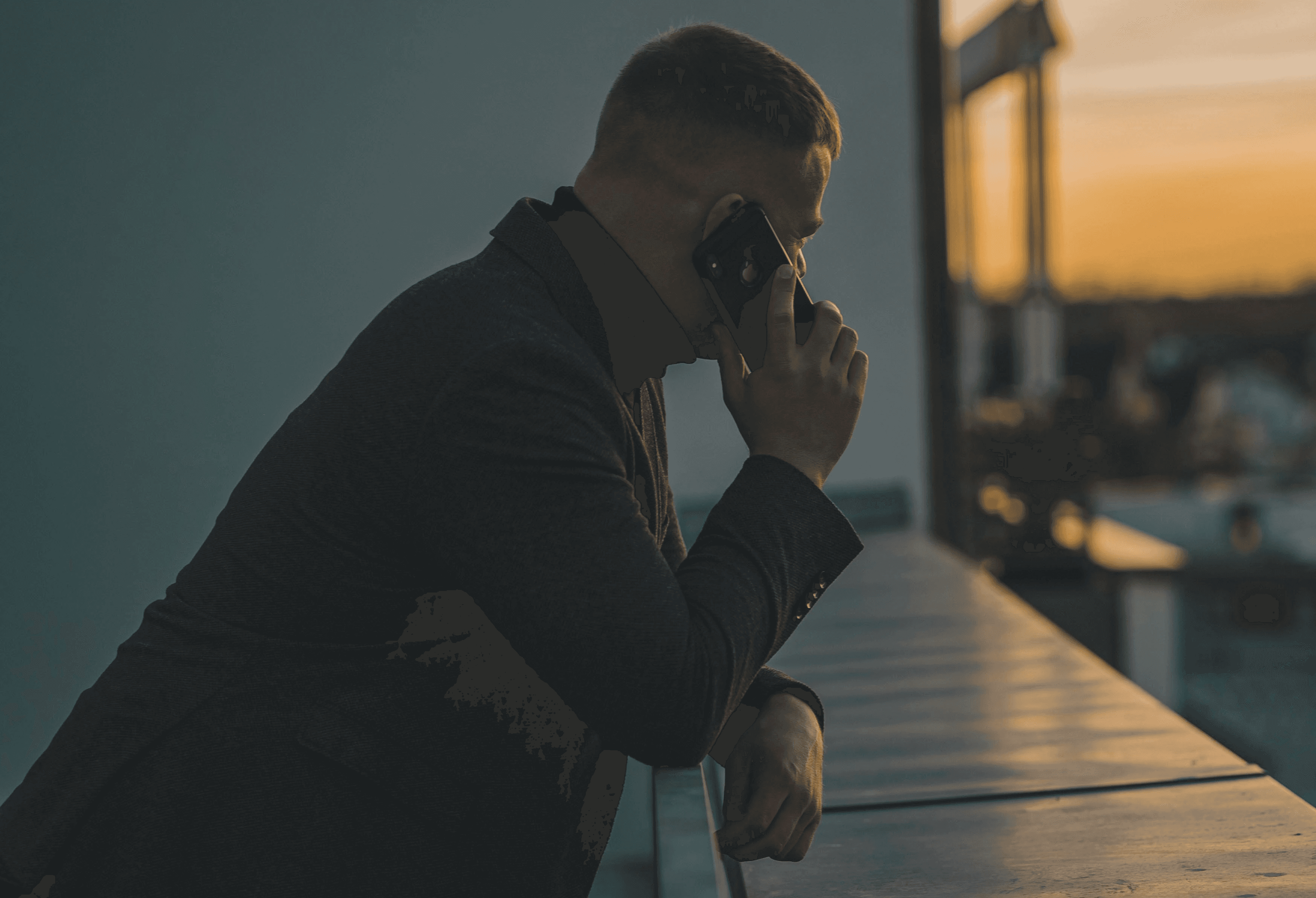man in black long sleeve shirt sitting by the table