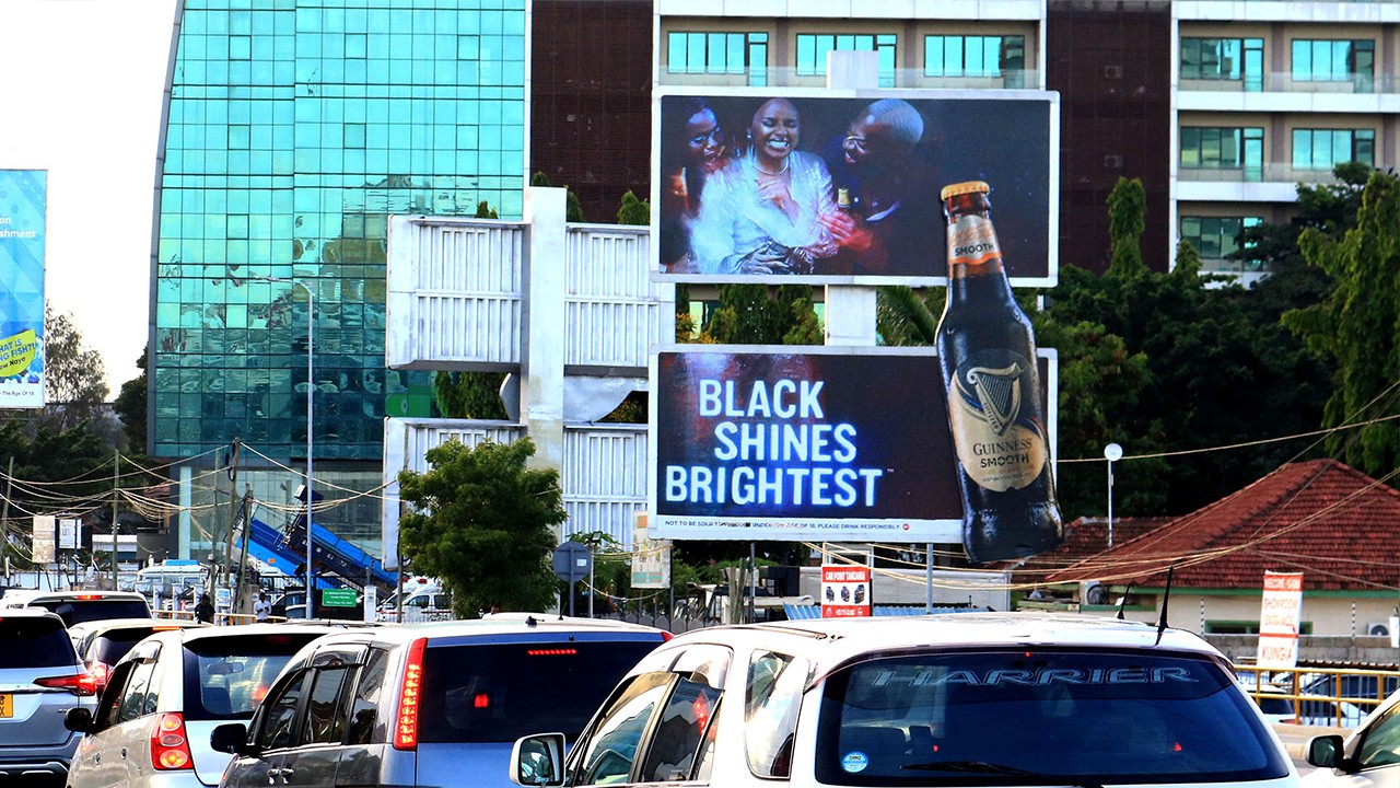 Luxury desert retreat with an infinity pool carved into natural rock formations, illuminated by warm evening lighting.