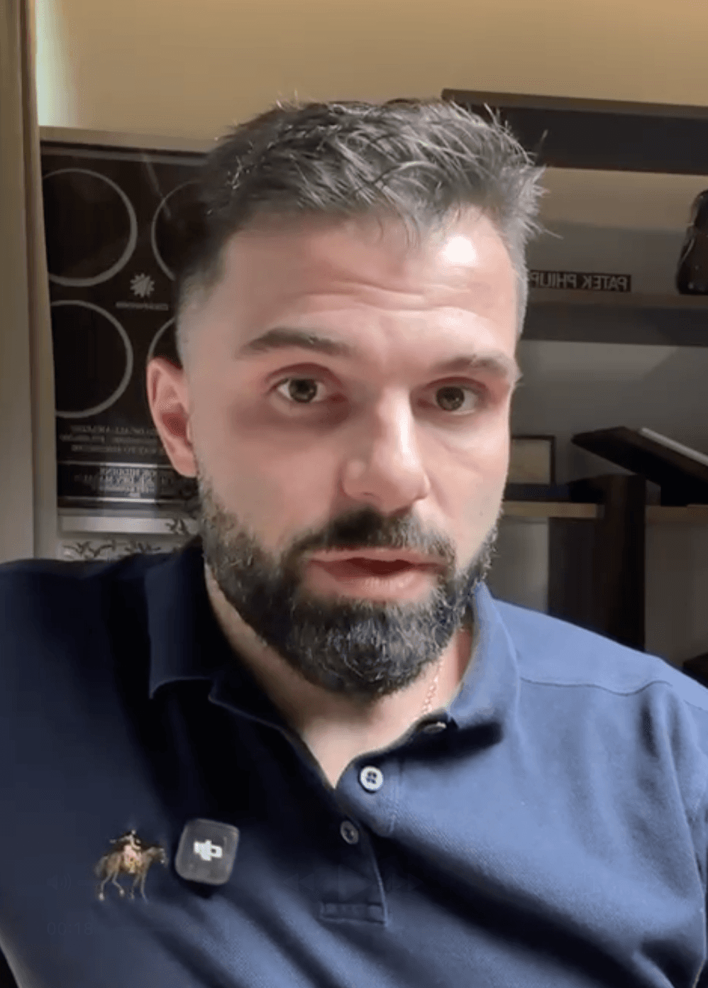 A man works on a laptop in an office.