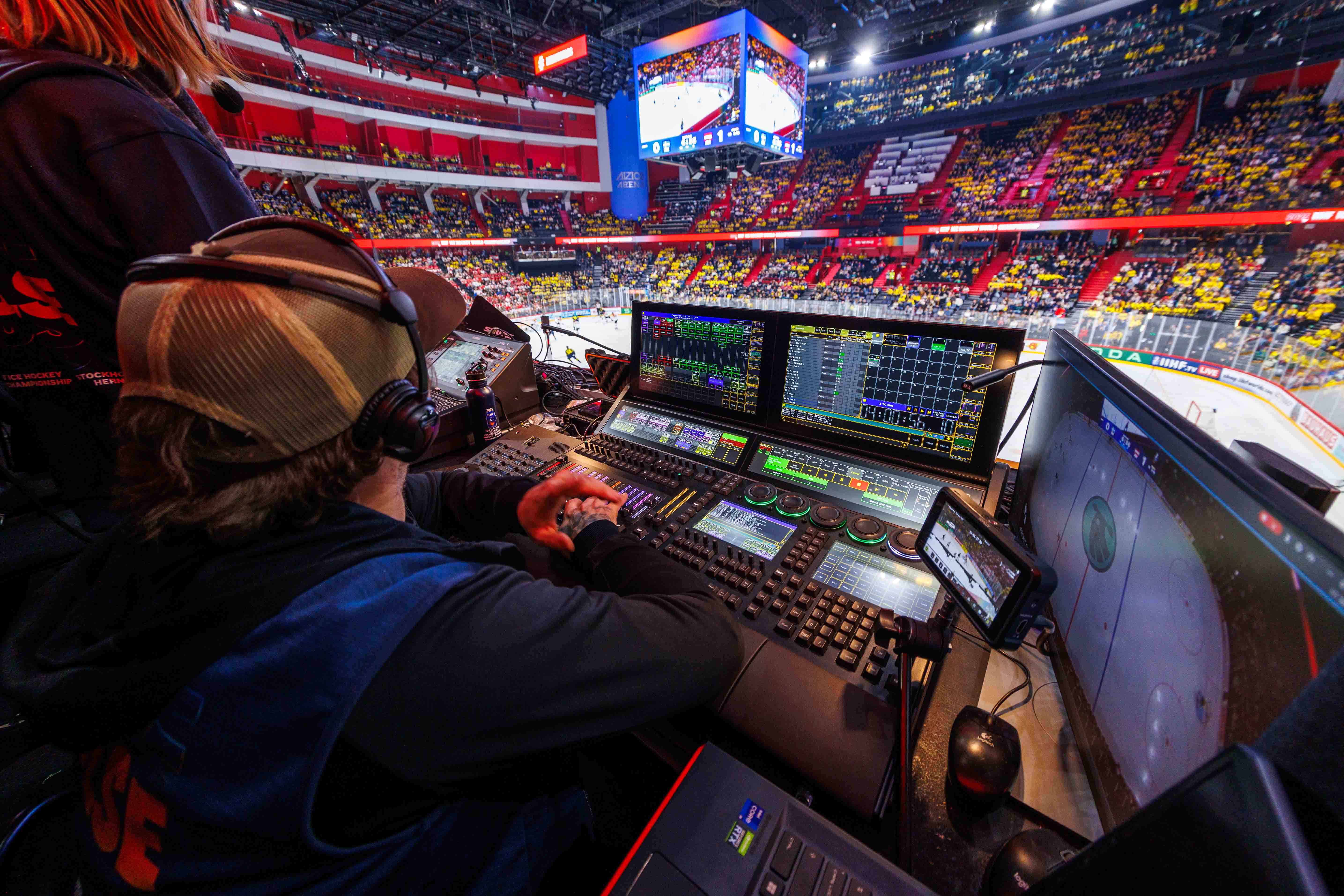 Behind-the-scenes look at a lighting technician from Creative Technology managing live production control during a match at the 2025 Ice Hockey World Championship, highlighting the scale and precision of the event’s technical execution.