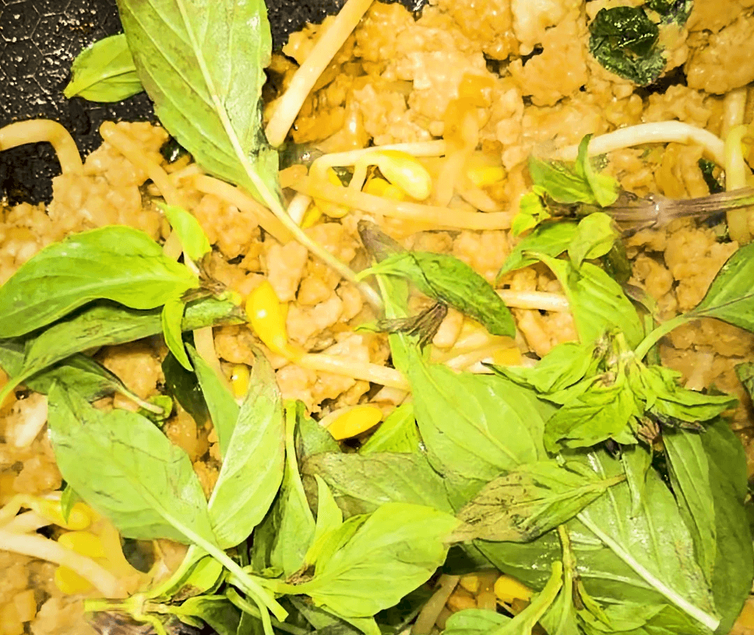 stir fried ground chicken with bean sprouts, green onion and lots of fresh thai basi