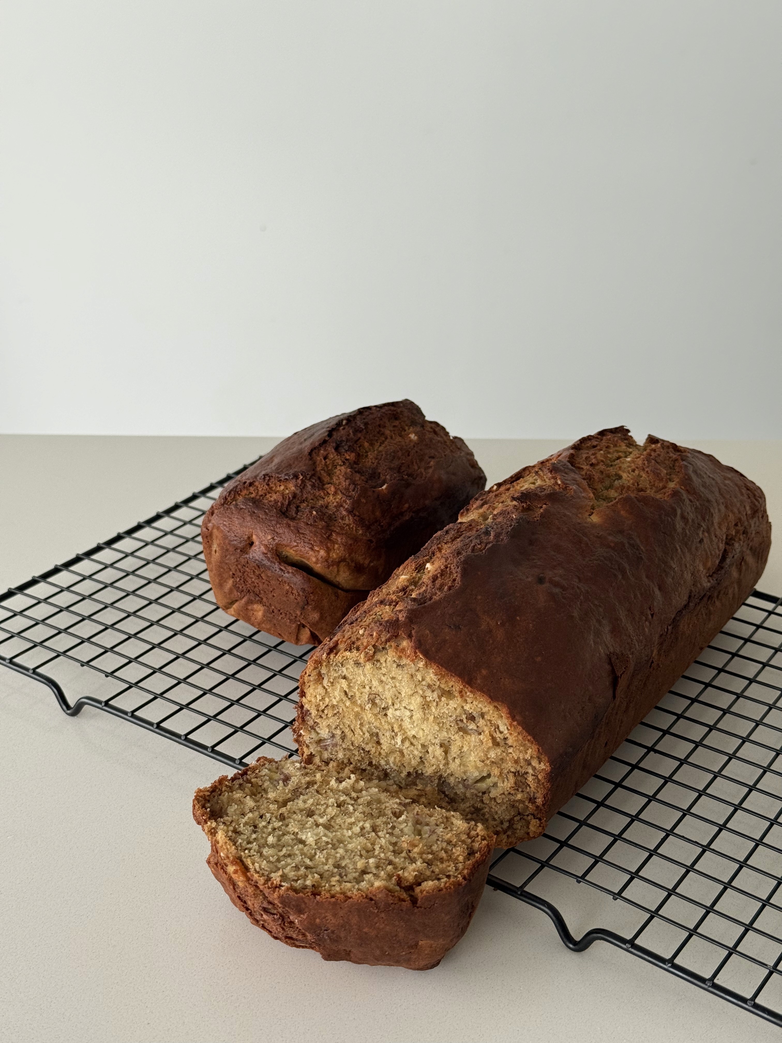 Sliced banana miso loaf resting on a cooling rack