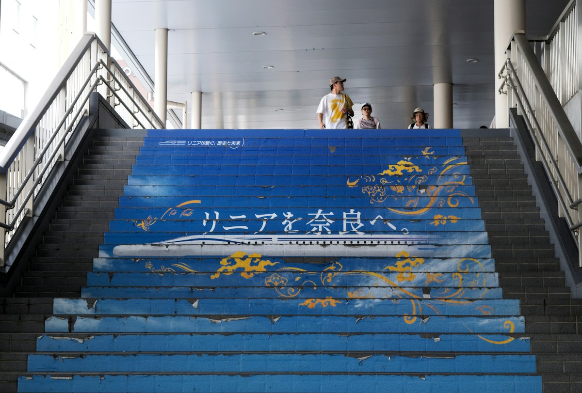 A station stairway mural welcoming visitors to Nara
