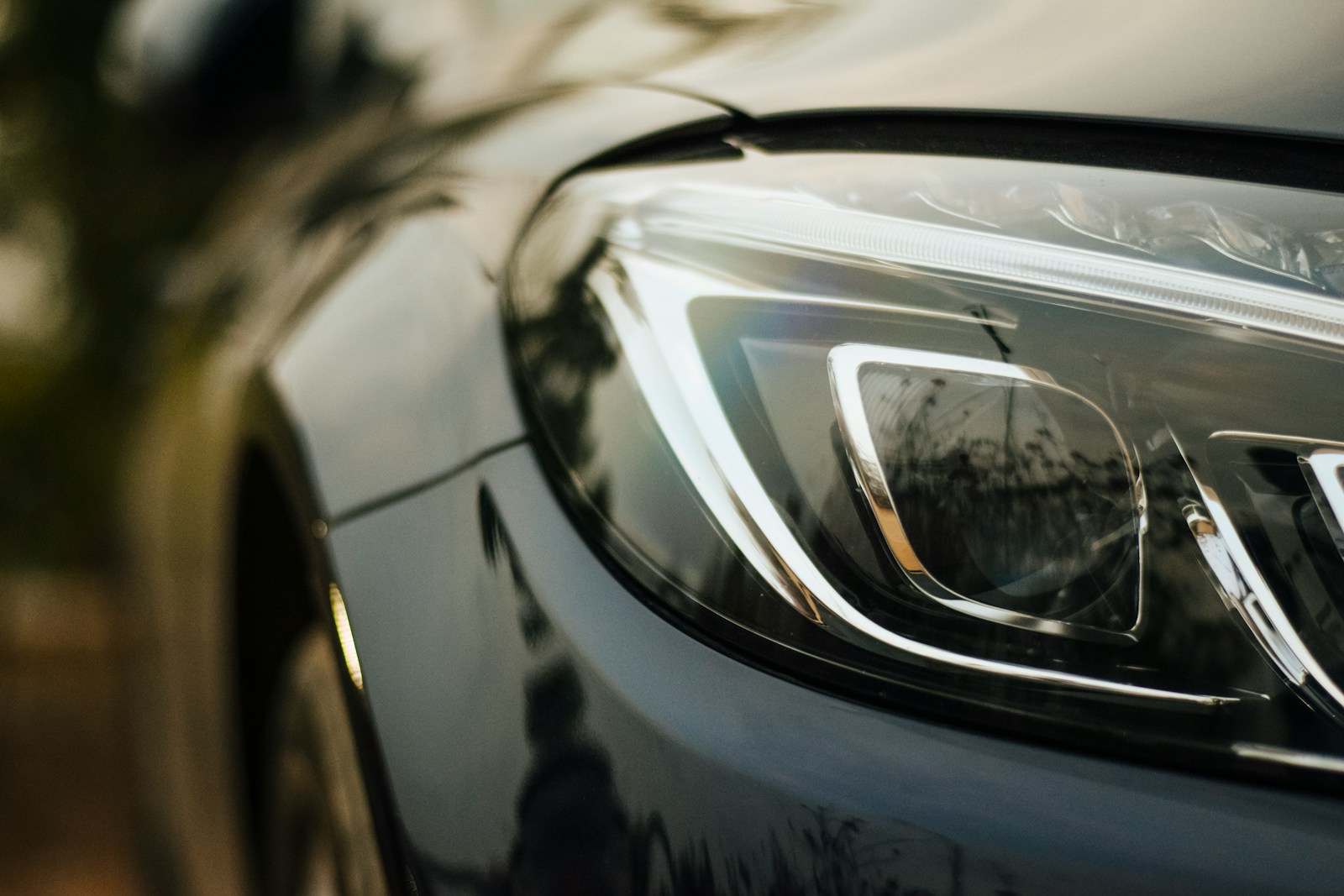 Glossy black vehicle headlight and protected paint