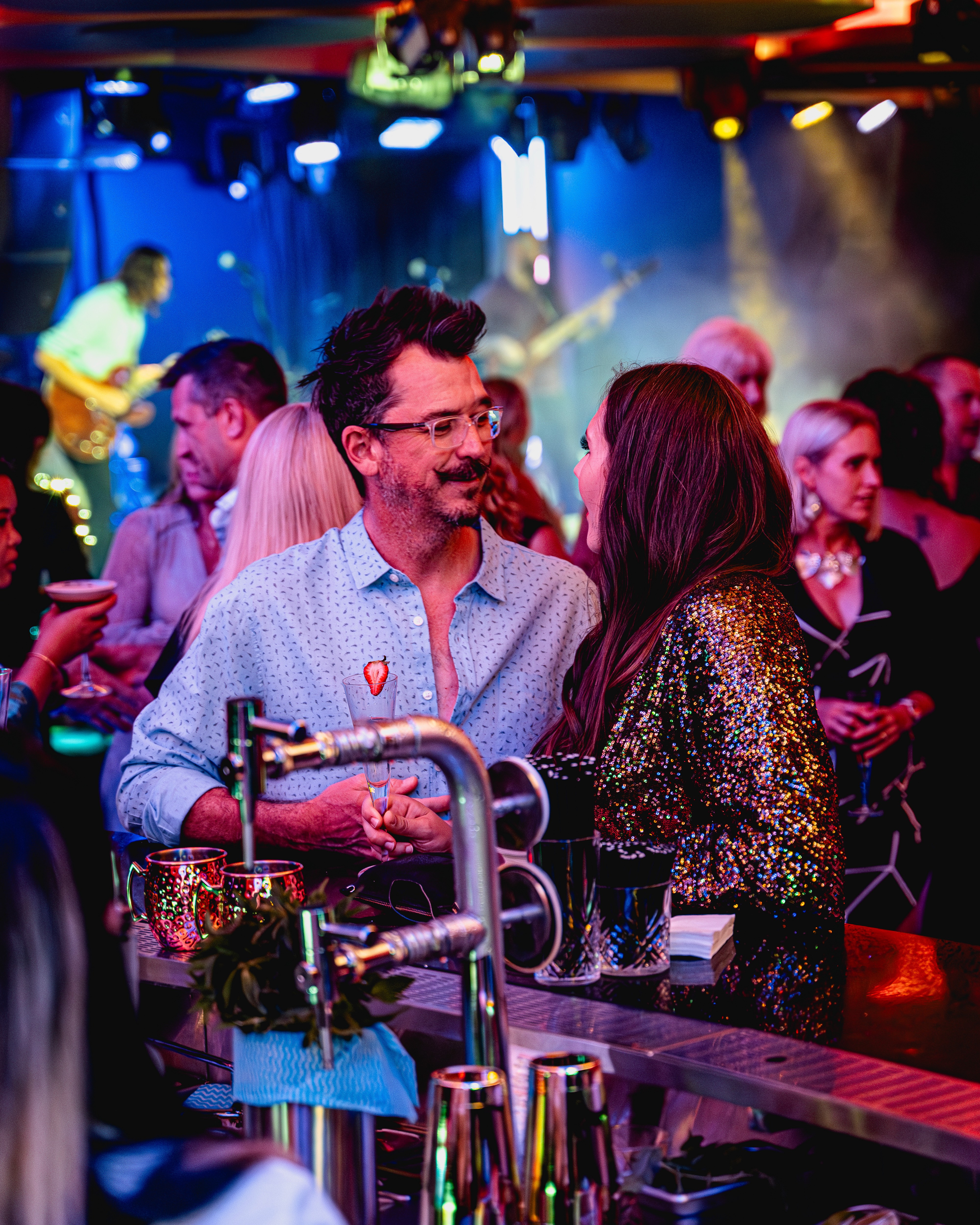 Candid lifestyle photography of guests enjoying drinks at Encore, highlighting the venue's social atmosphere and premium hospitality.