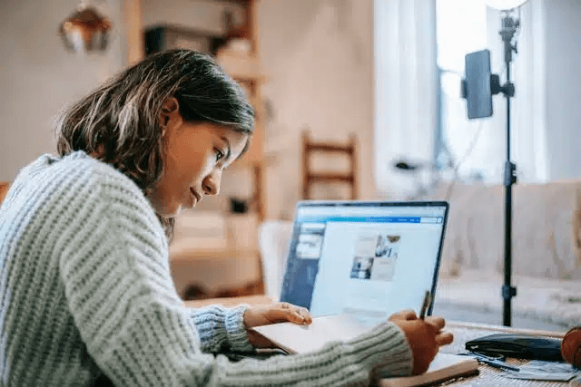High school student submitting a research paper to the National High School Journal of Science on a laptop