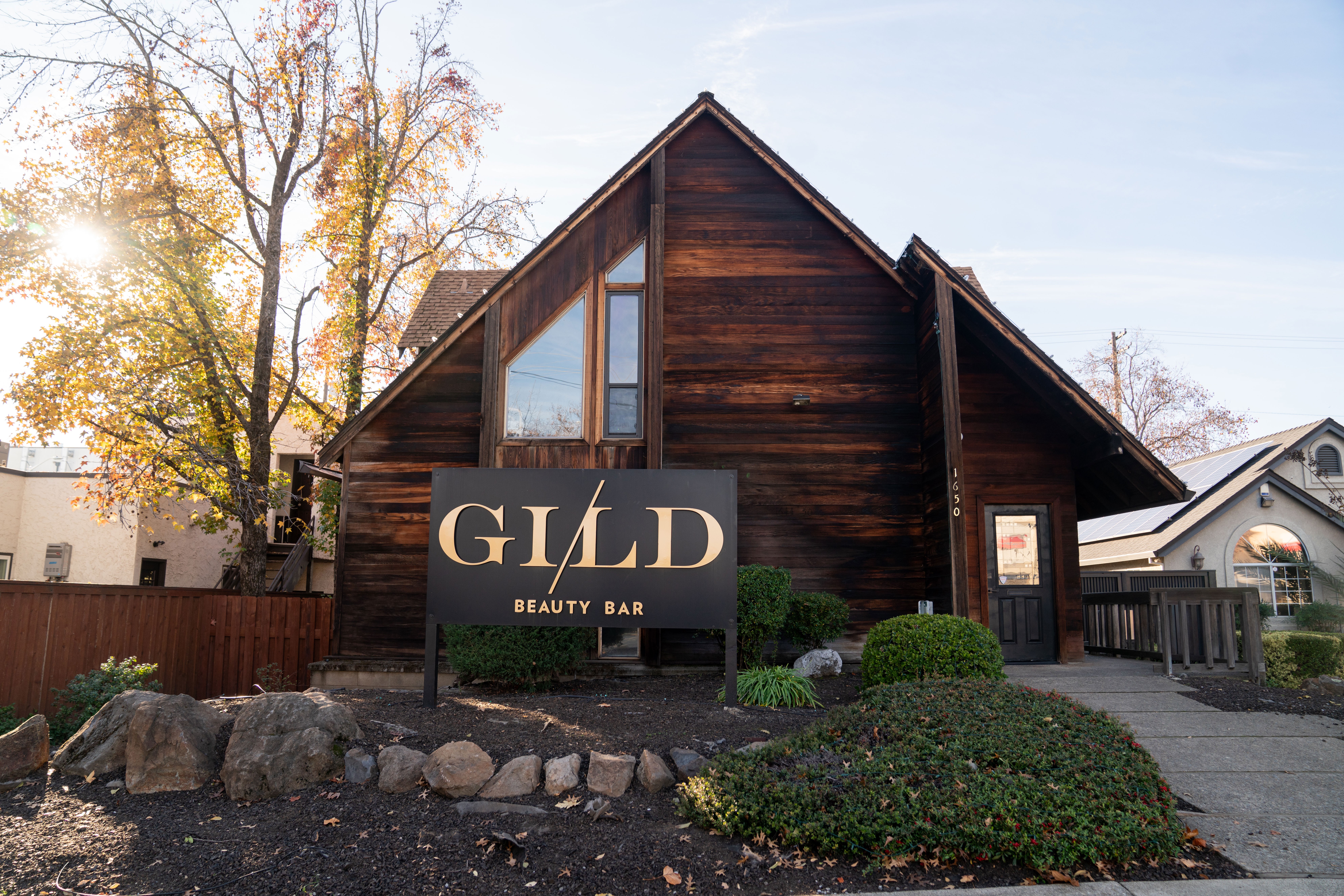 Black and white image of people working at a table with laptops, showing hands gesturing during discussion of digital content displayed on screens, with fabrica® logo in the corner.