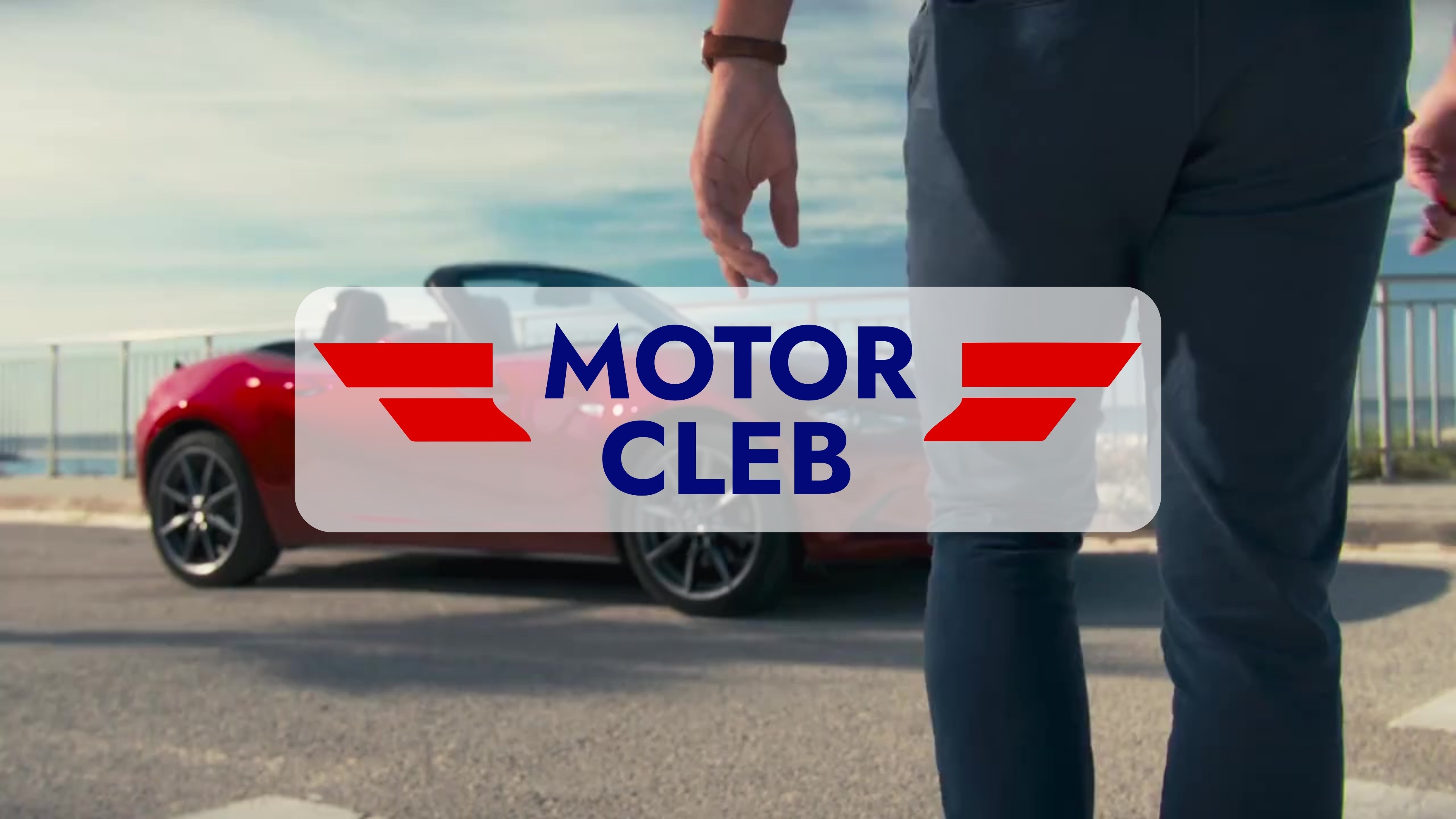 Two happy men driving a sportscar with a joyful expression, ideal for car rental adventure promotions.