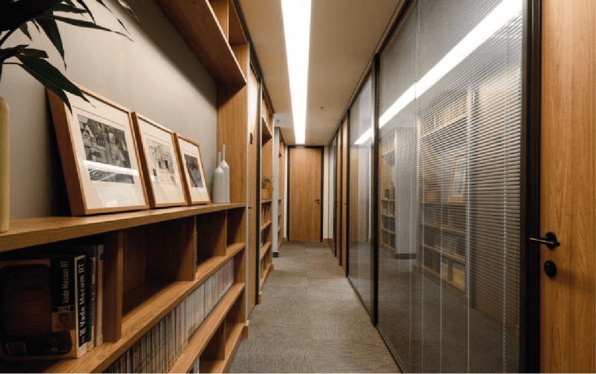 Contemporary interior with sculpted angled walls and a skylight filling the space with natural light.