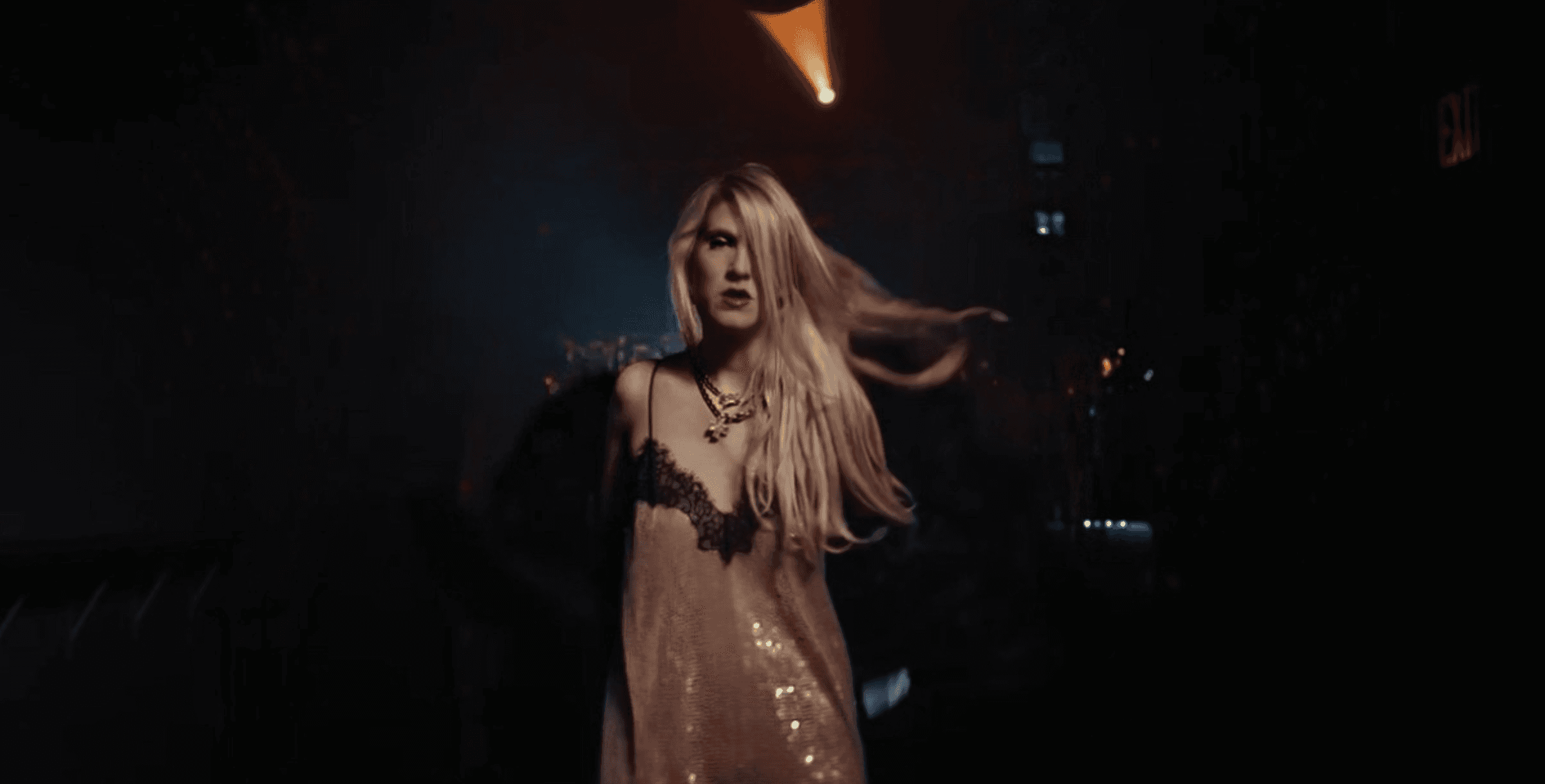 View of the French countryside through a stone villa’s open living room, with sofas and trees framing the scene
