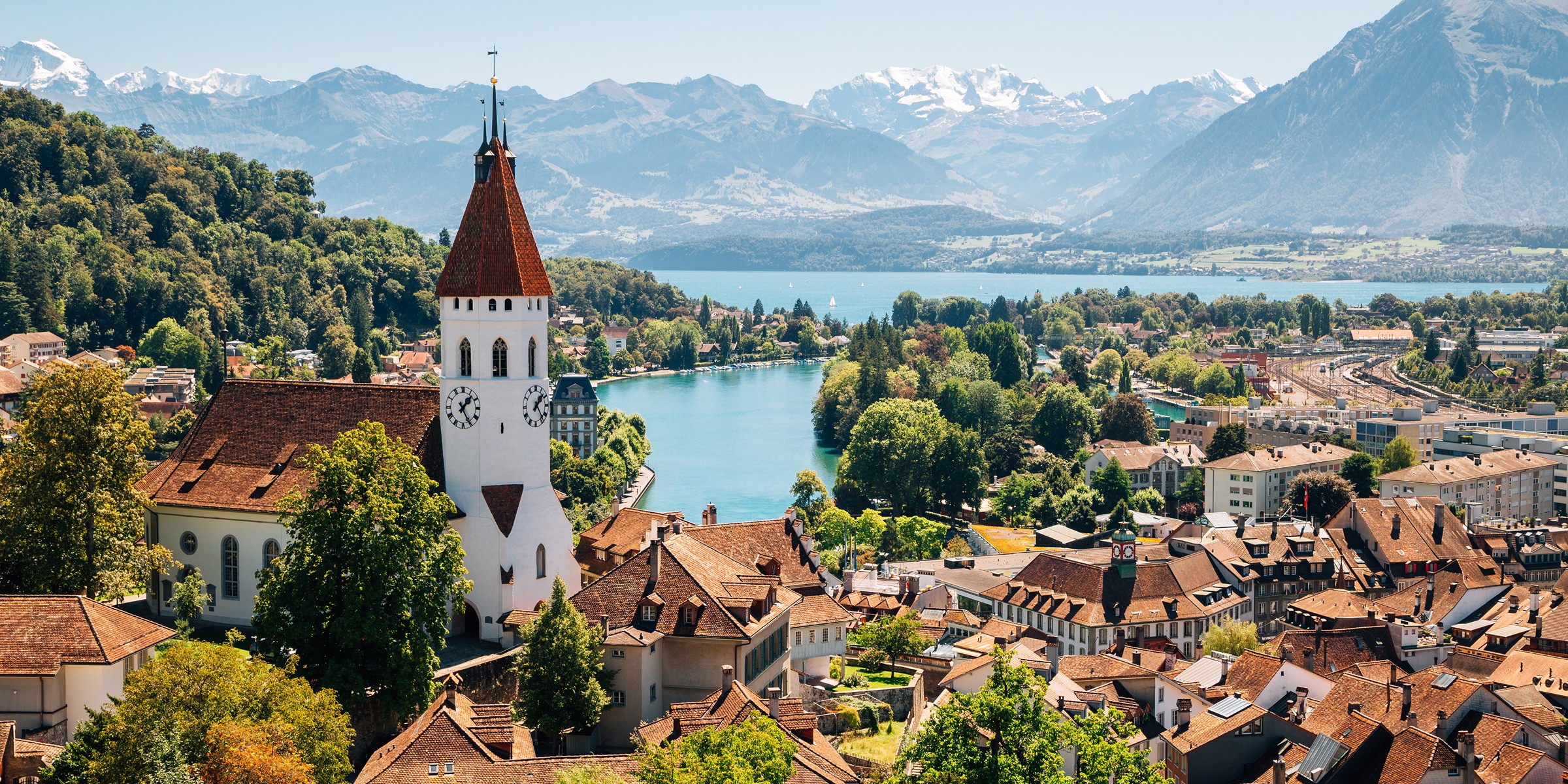 Thun church tower with Lake Thun and the Alps behind, Switzerland