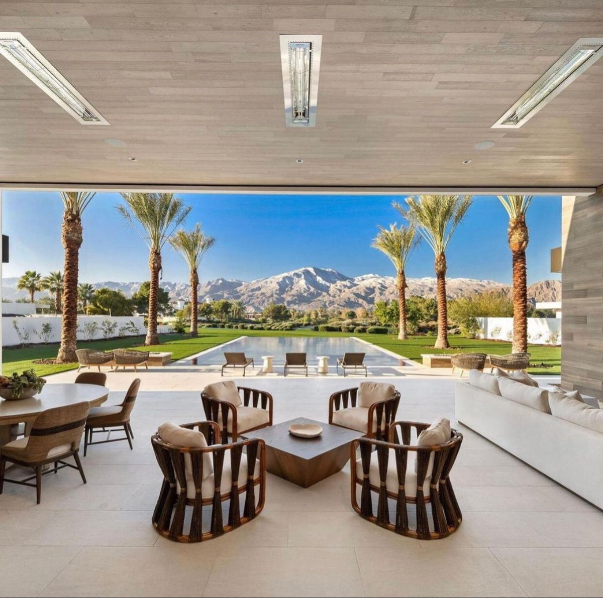 Open living area facing a pool and desert mountains, architectural reference photograph