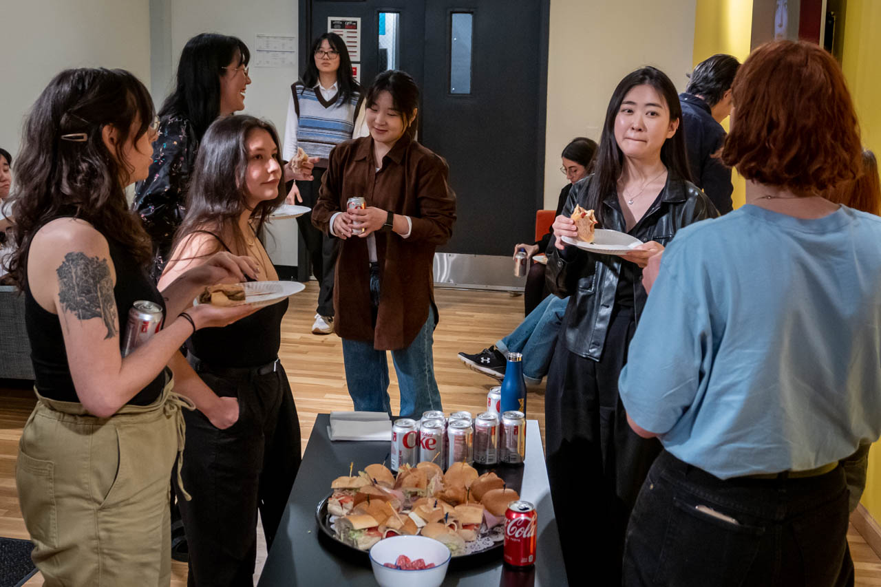students on break from Defense session, eating snacks