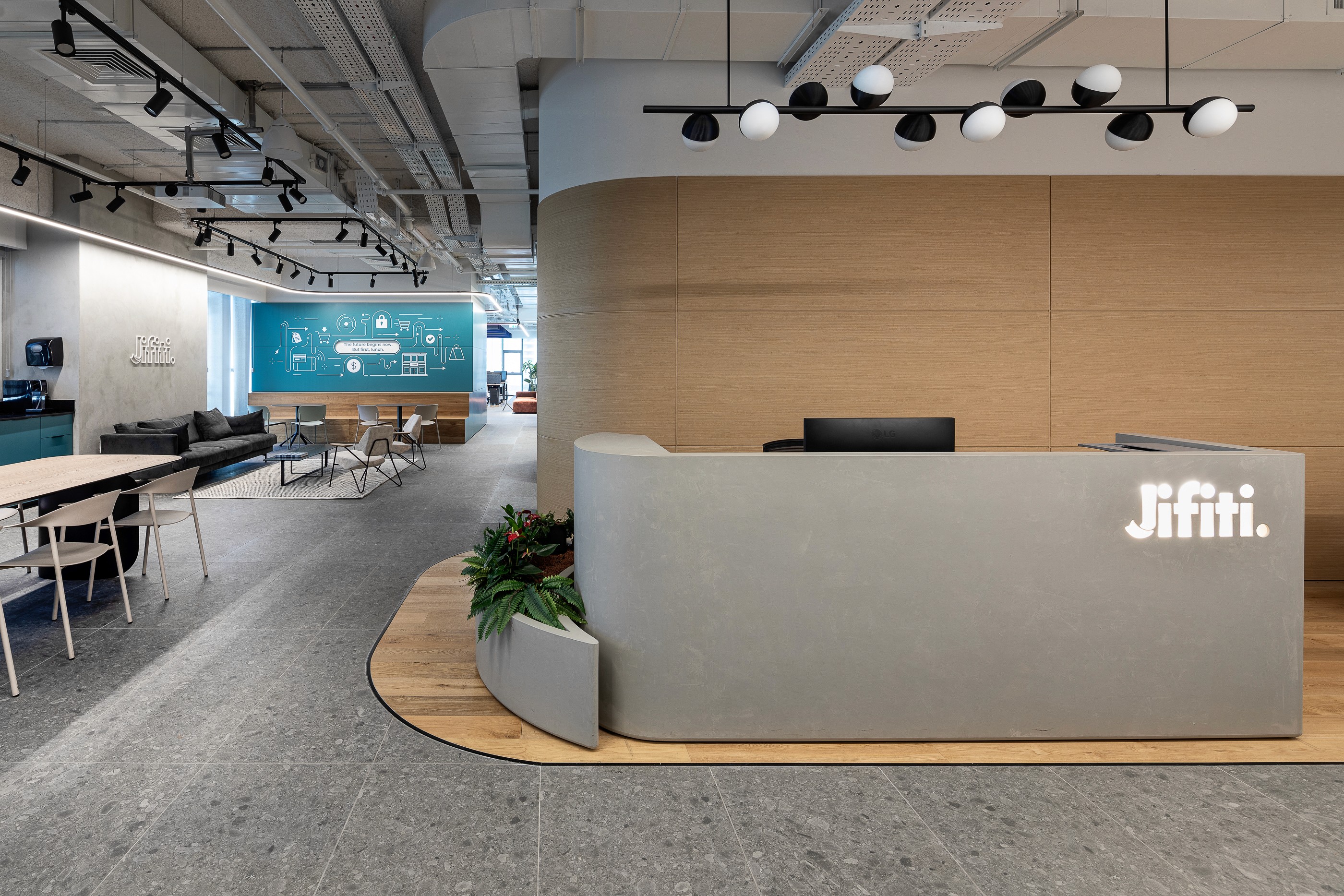 Entrance to Jifiti offices featuring curved wooden walls and modern design