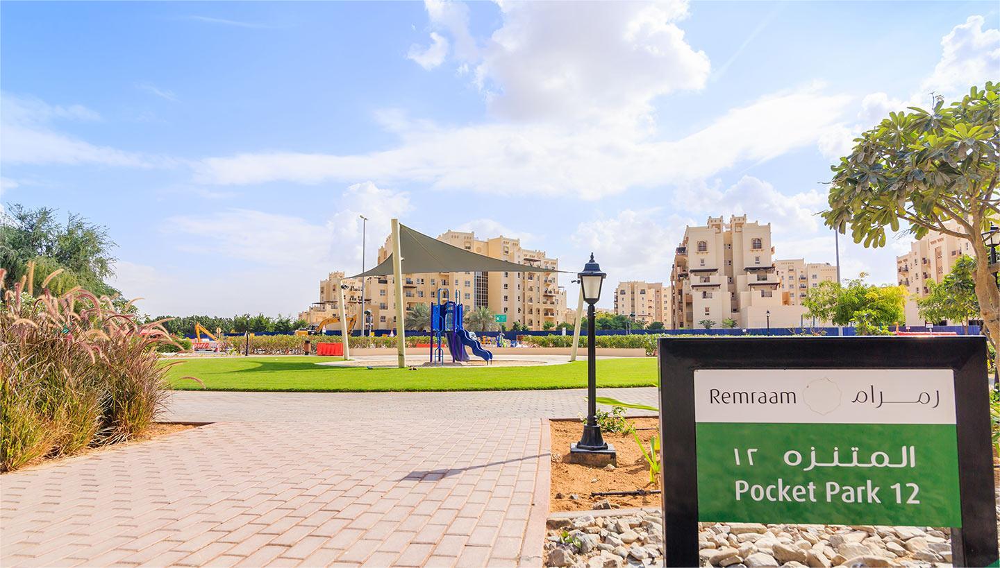 Remraam Dubai residential zone with modern apartments and shaded outdoor gym promoting active urban living.