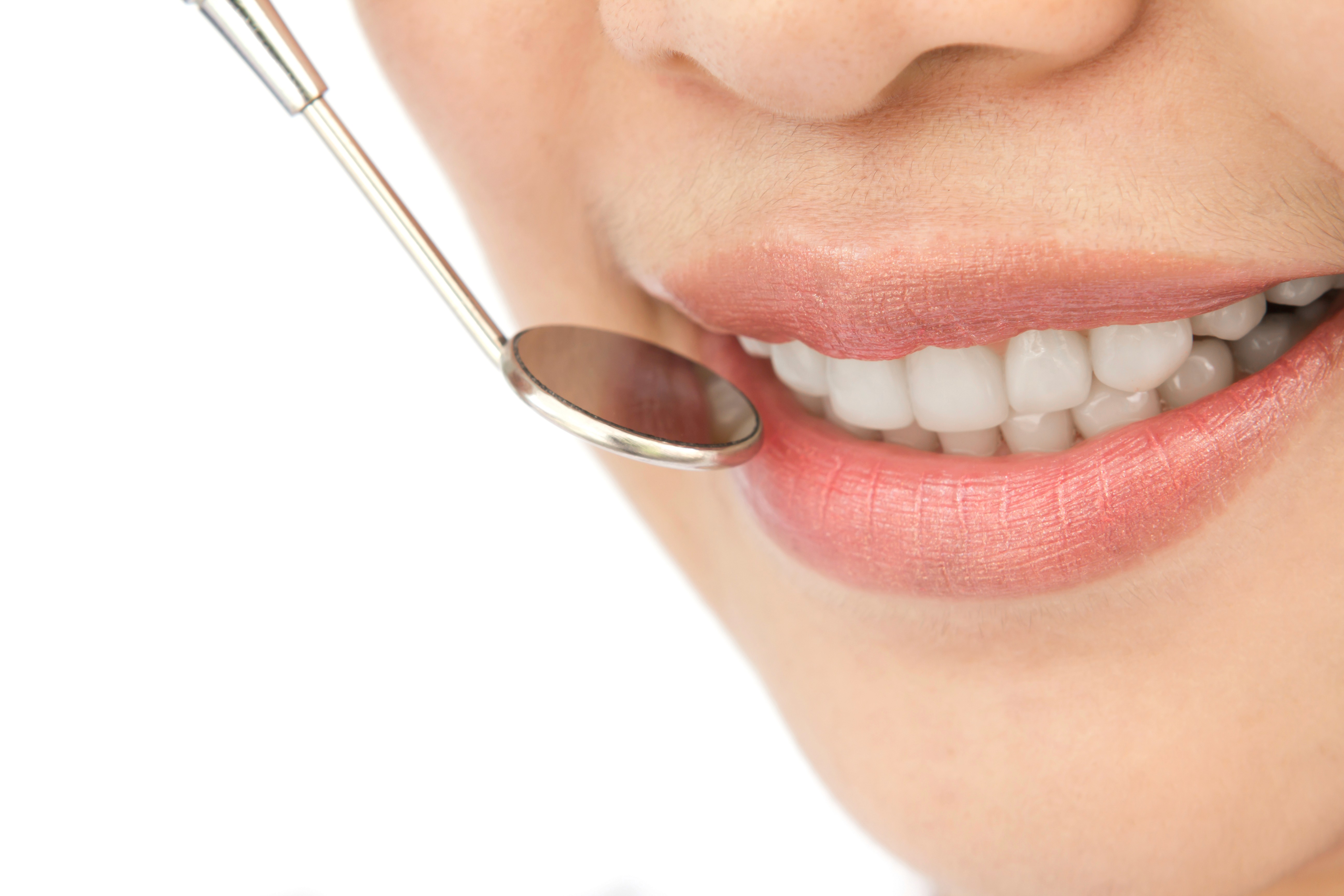 Close-up of a bright smile during cosmetic dental treatment with dental tools