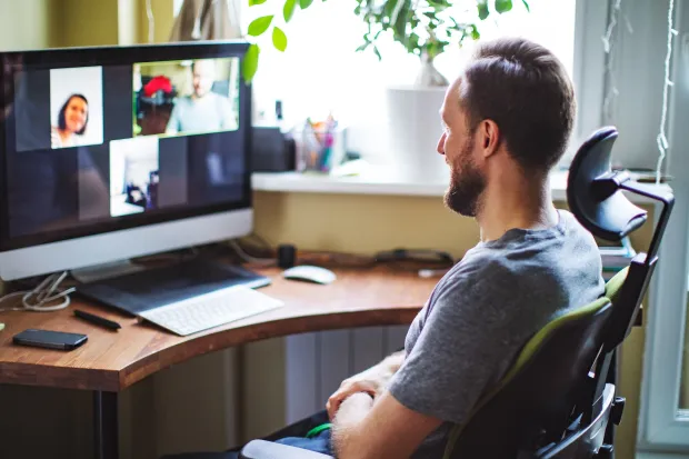 four persons sitting on chairs near window during daytime